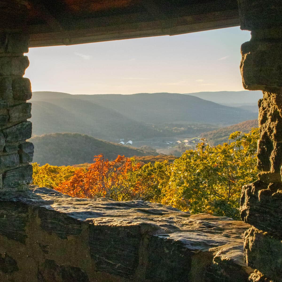sunset view of rolling green hills out a tower window in connecticut.
