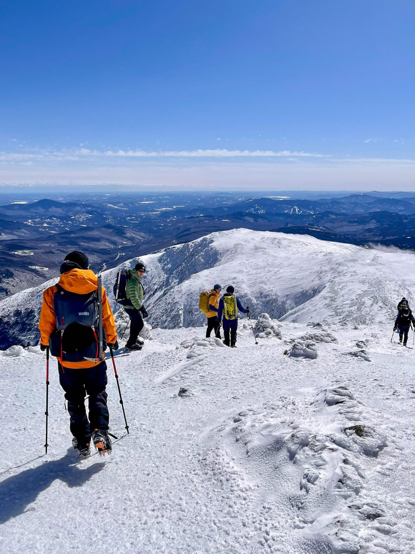 group hiking on mount washington hike in the winter with snow
