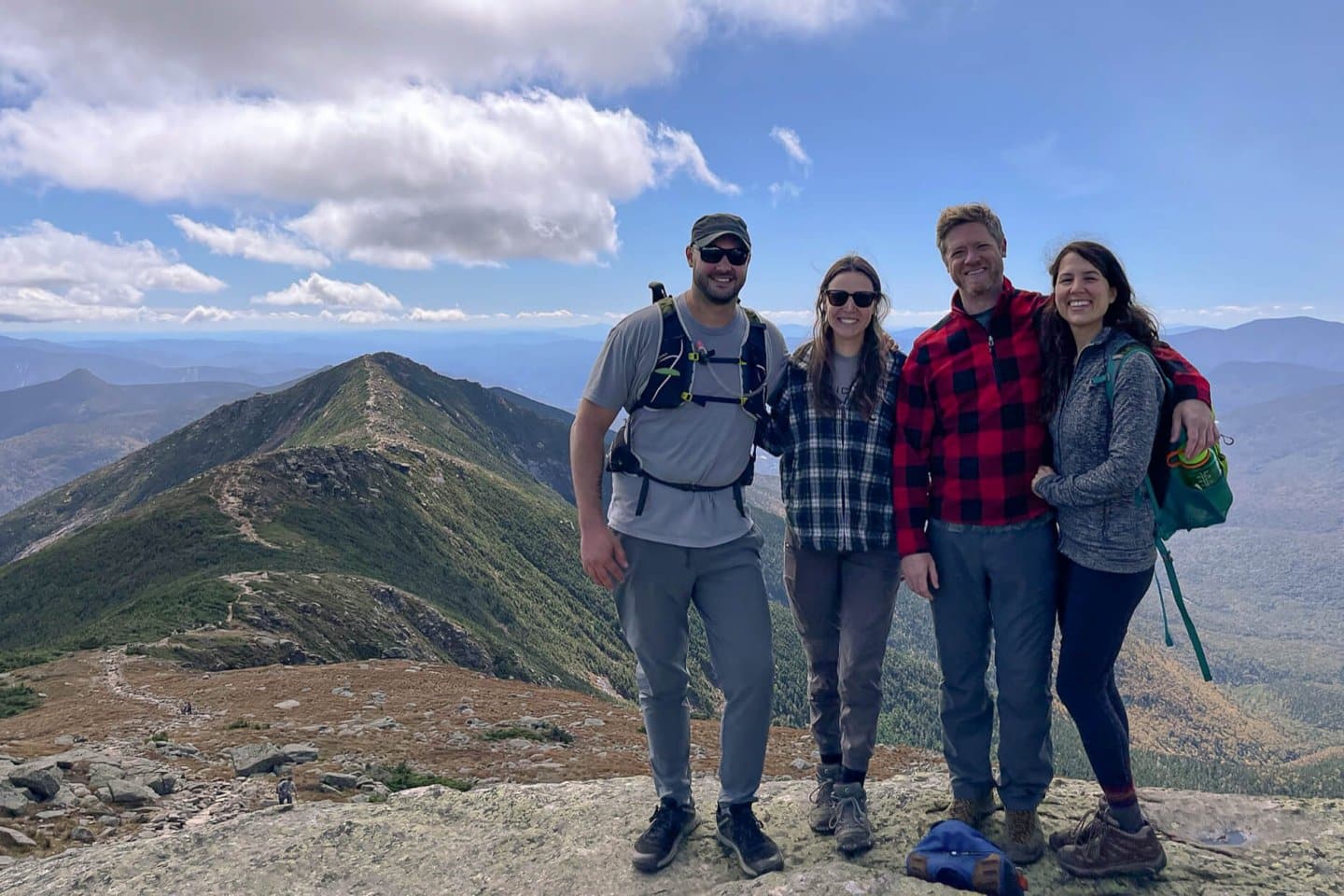 group of friends atop a mountain in New Hampshire