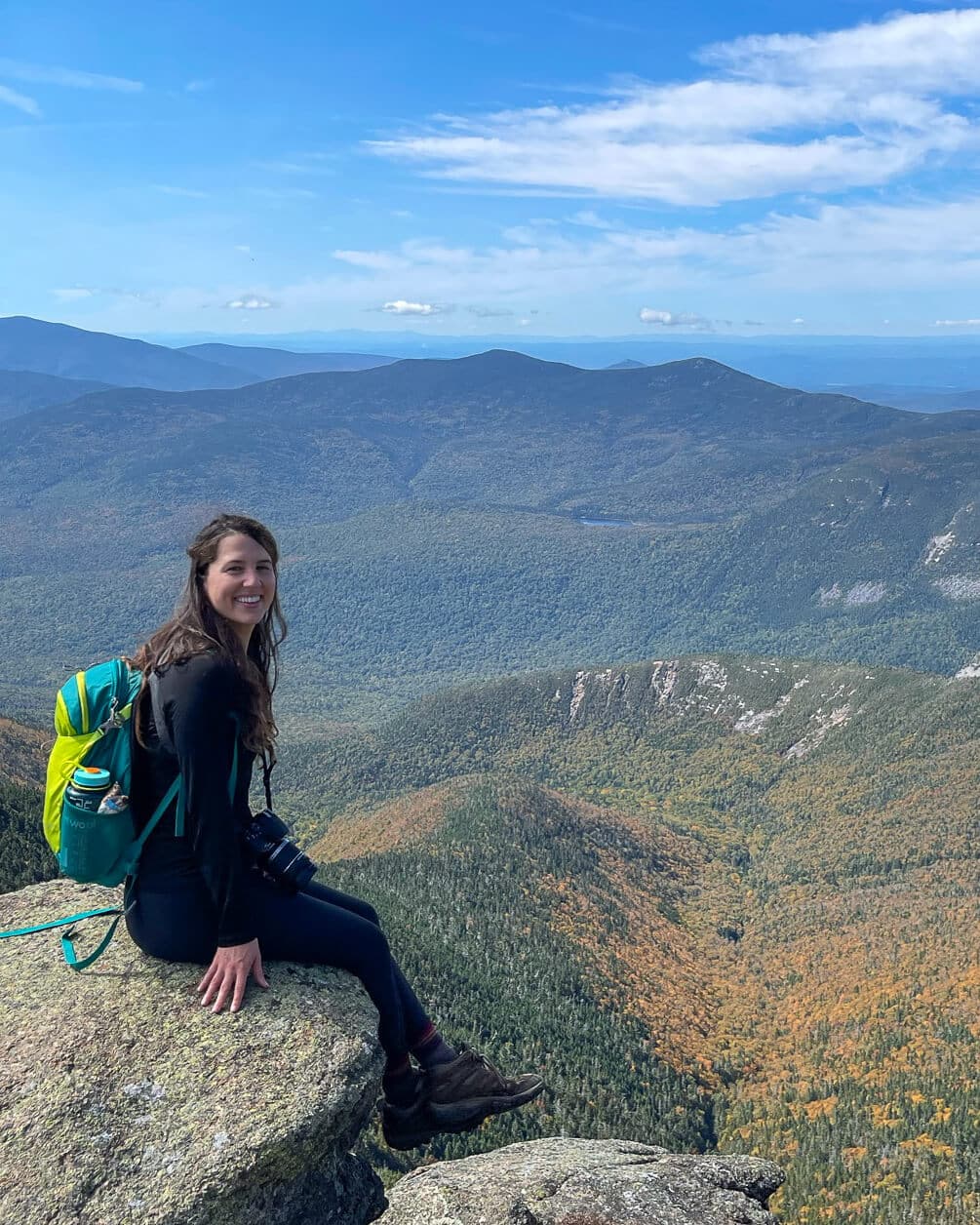 girl on edge of cliff in New Hampshire mountains