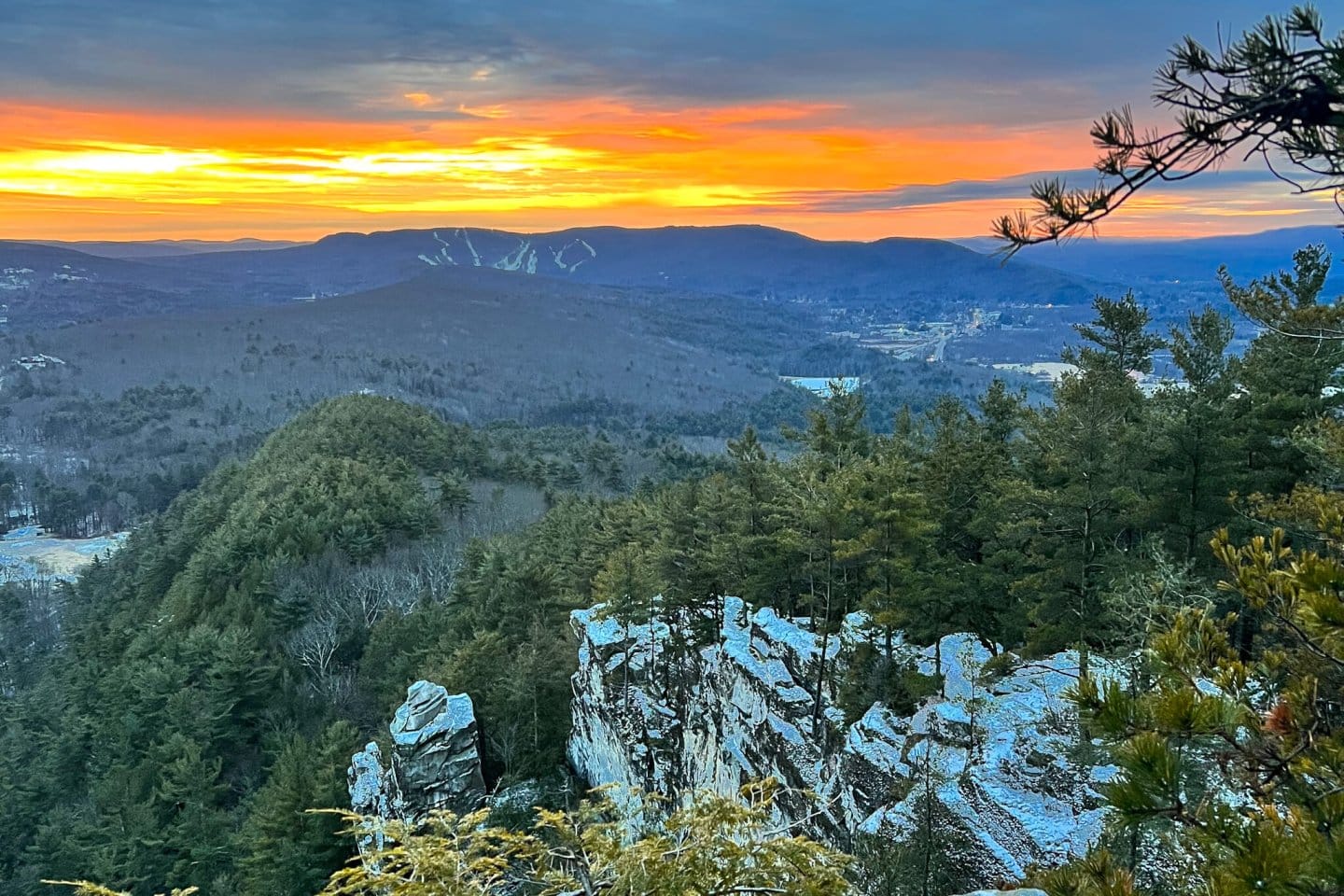 sunrise view from a snowy mountain with yellow and orange colors in the sky