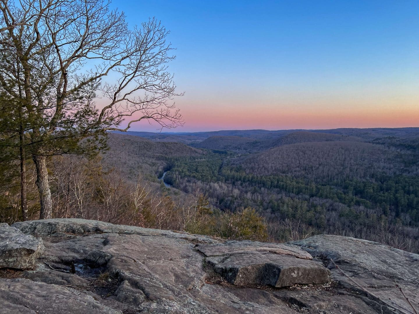 sunset view on mountain top with pink and blue skies in early winter