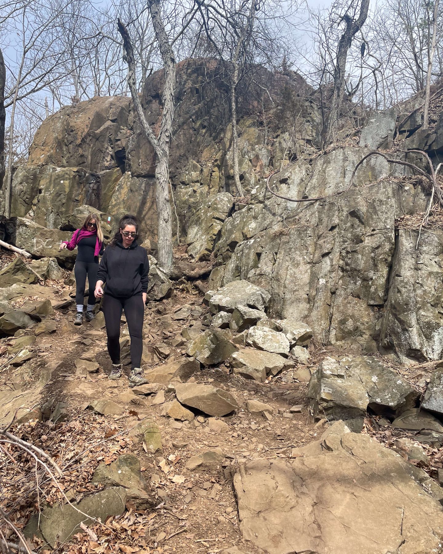 2 women hiking down a trail