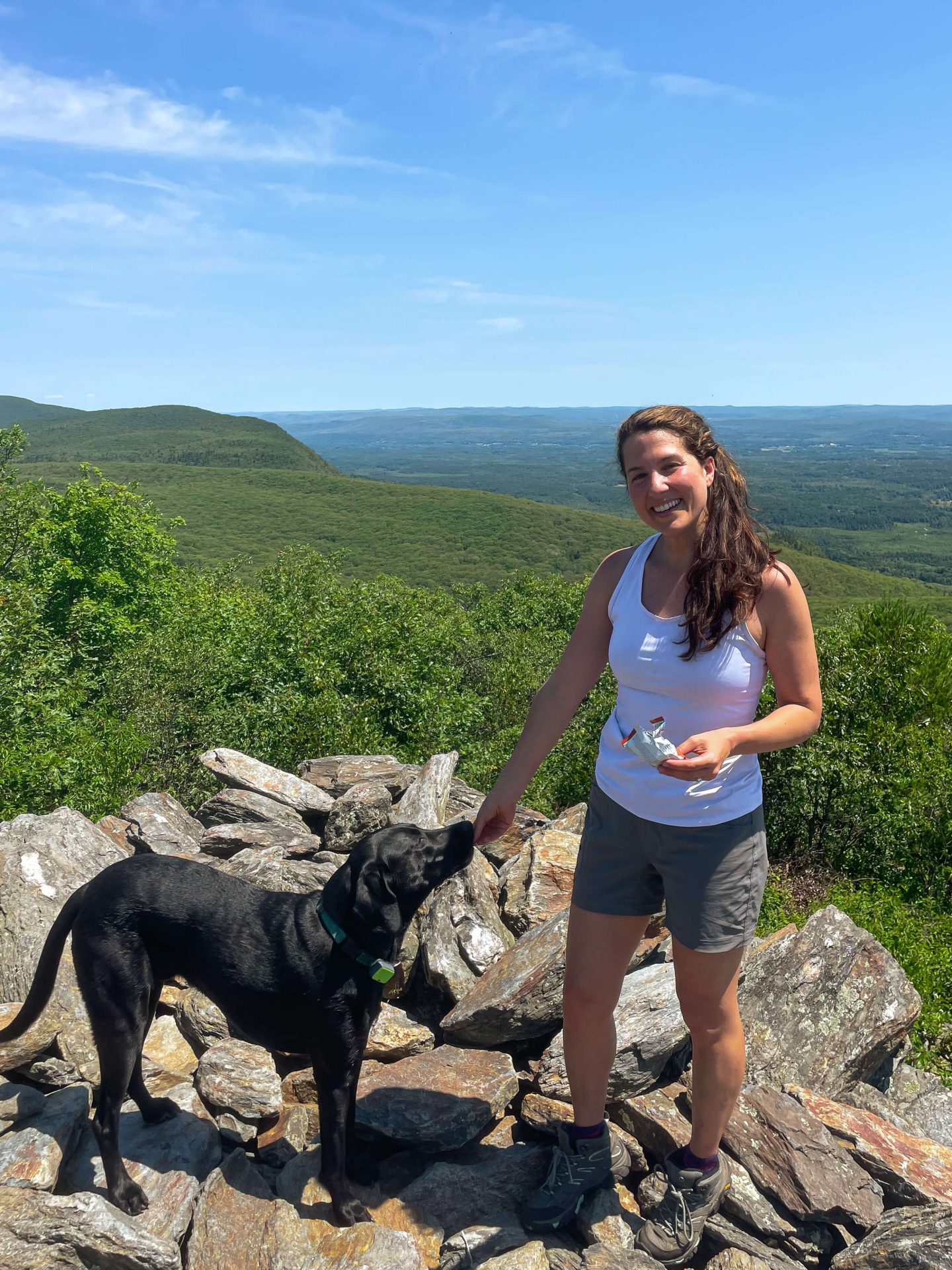 woman in white tank top on bear mountain connecticut in summer