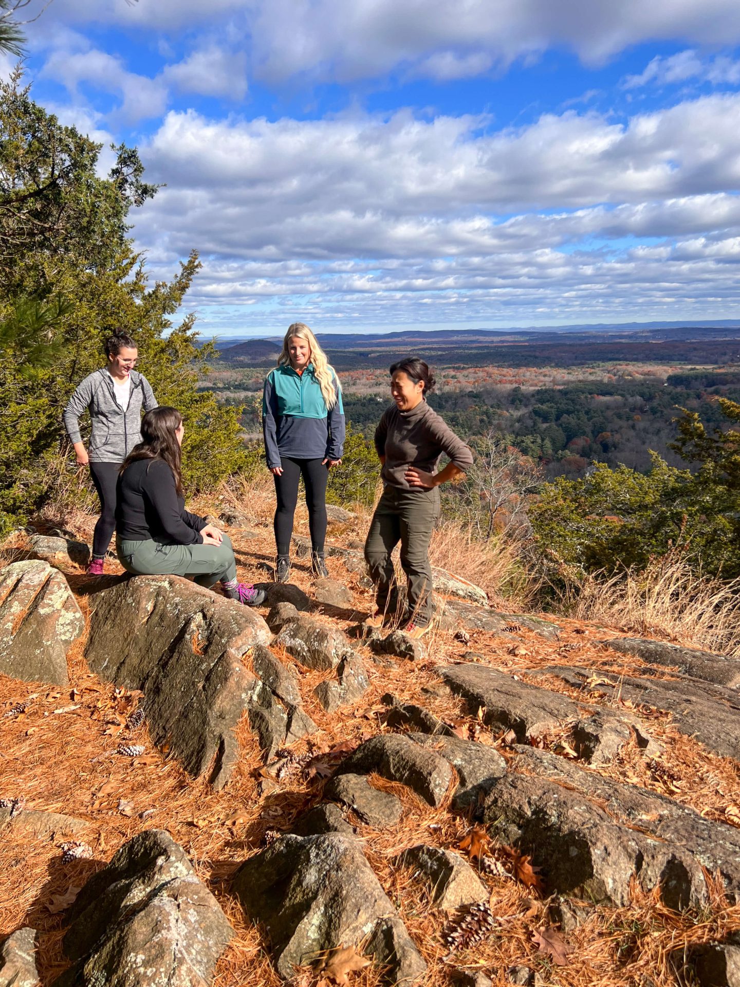 group of female hikers on top of west mountain in simsbury connecticut on a late fall day