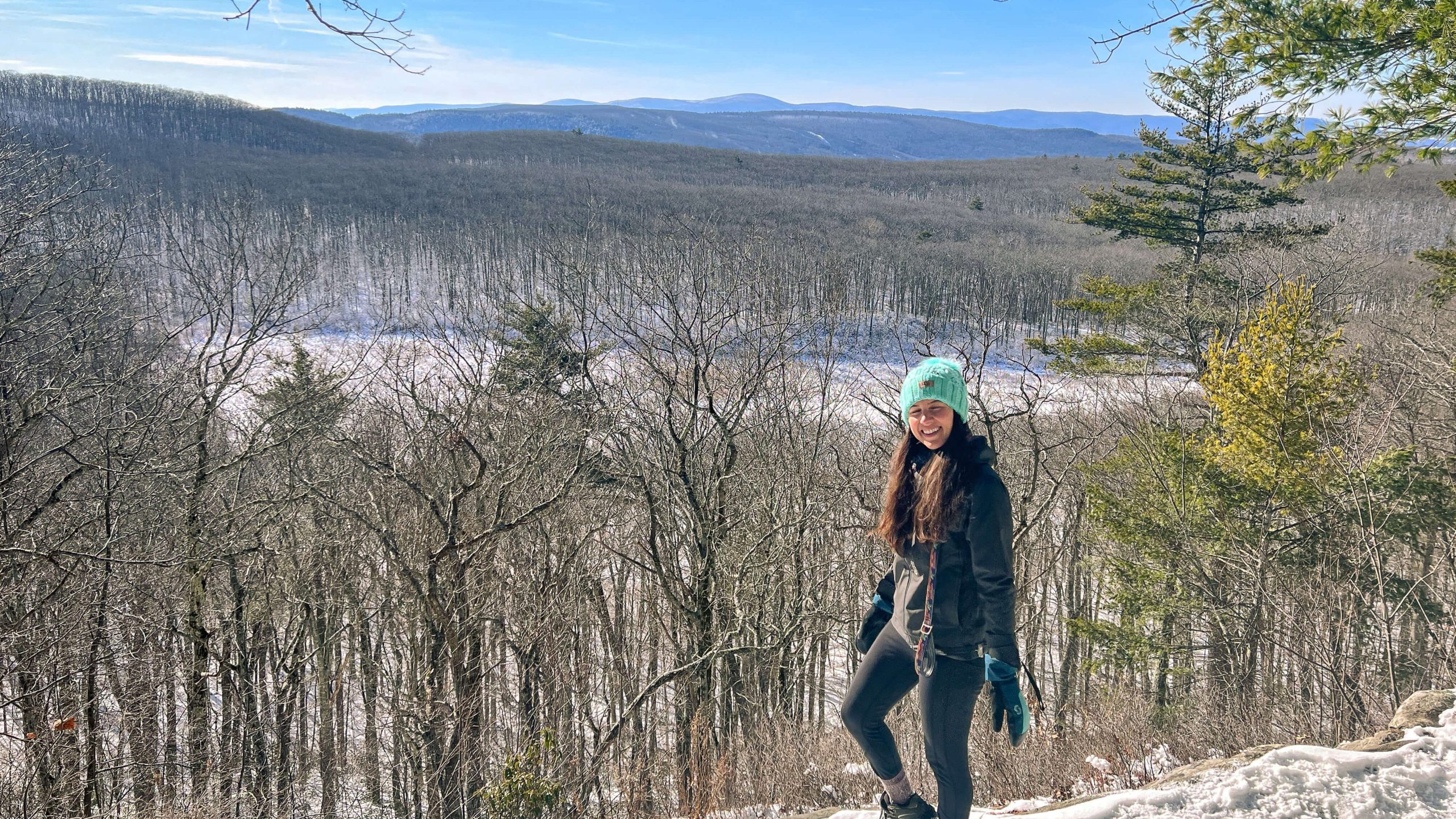 woman smiling on a winter hike with snow in the berkshires