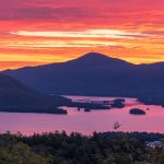 sunrise hike over lake george with pink and orange sky