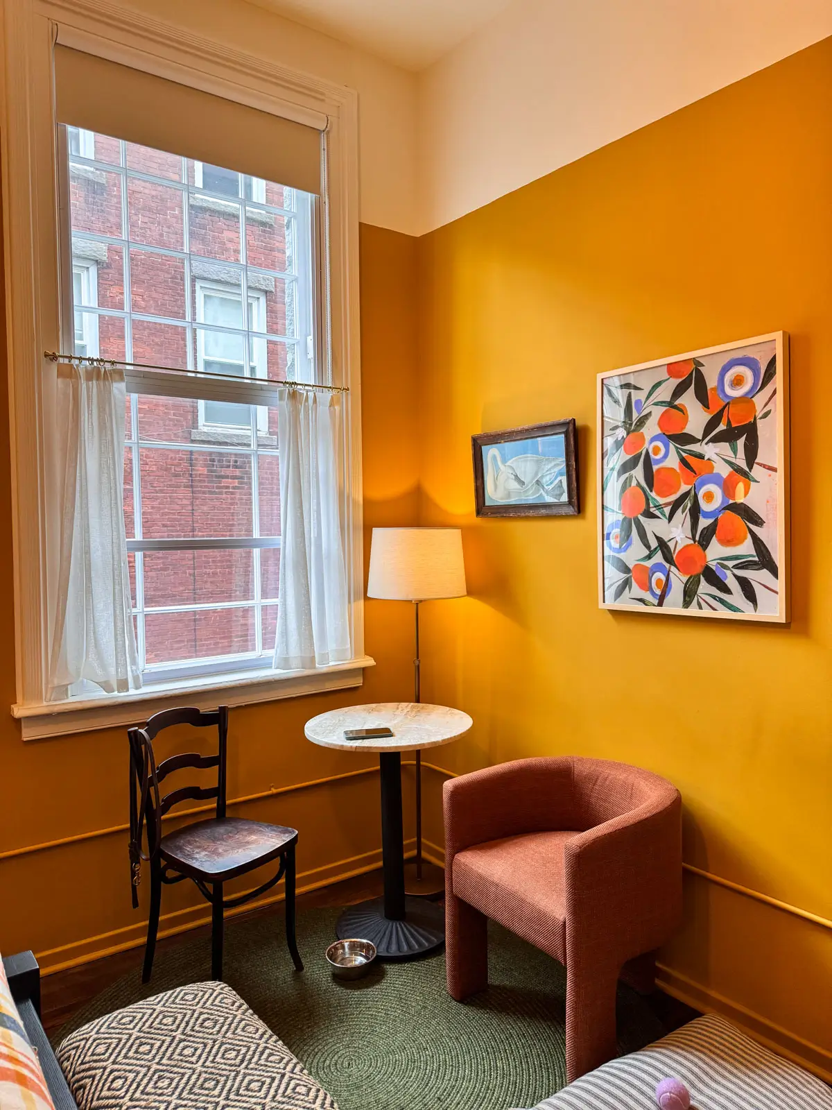 room with yellow walls and sitting area at The Abner Hotel in downtown Litchfield, CT.