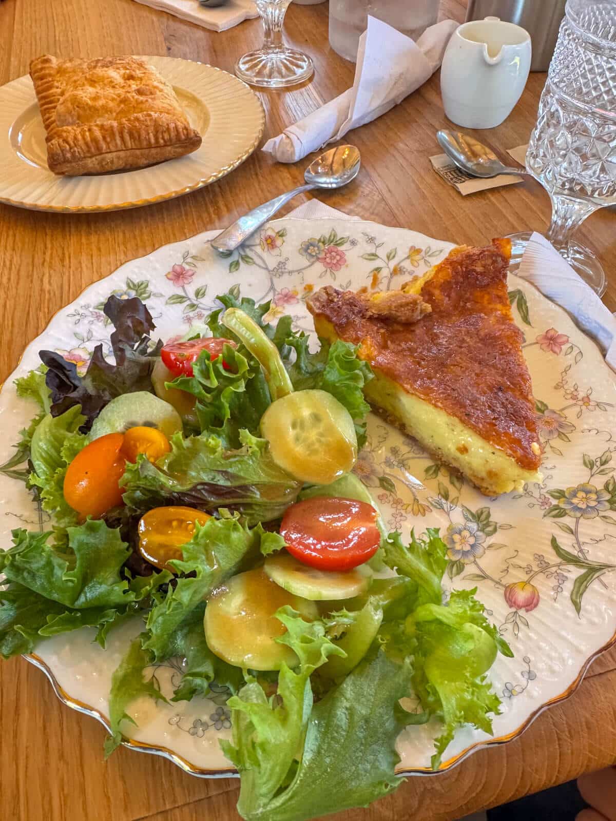 quiche and green salad on a flowered plate at a british tea room in morris connecticut.