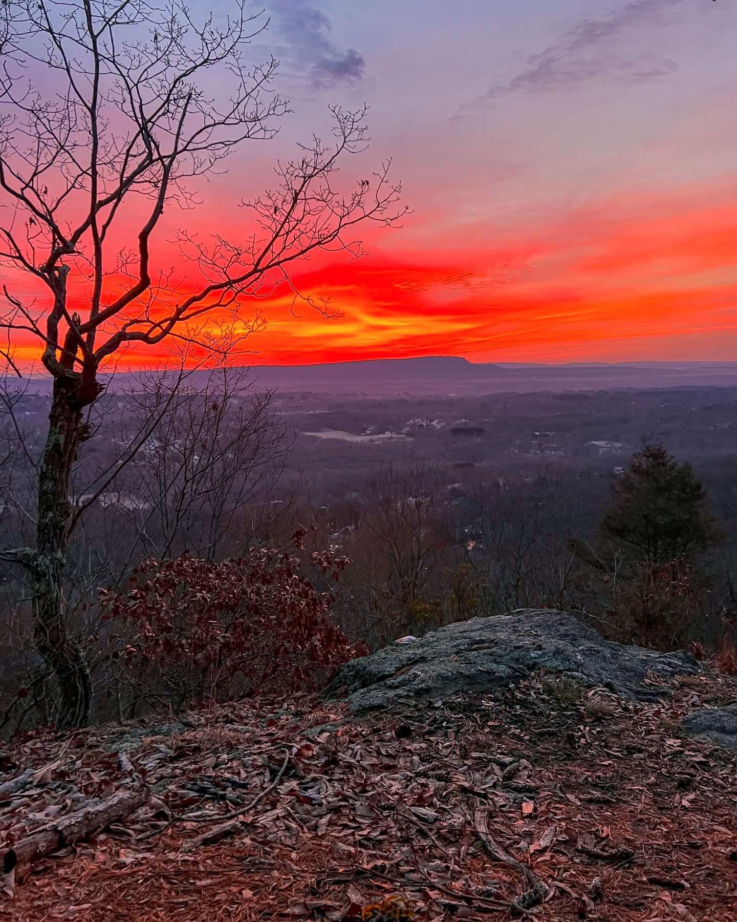 red sunrise colors in the sky on tunnel falls hike in connecticut