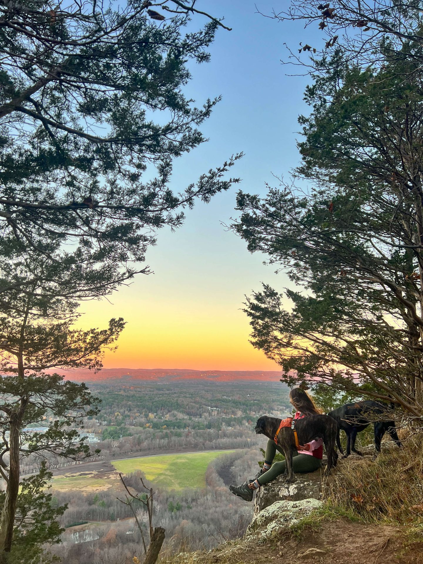 woman and dog on sunset hike at talcott mountain state park