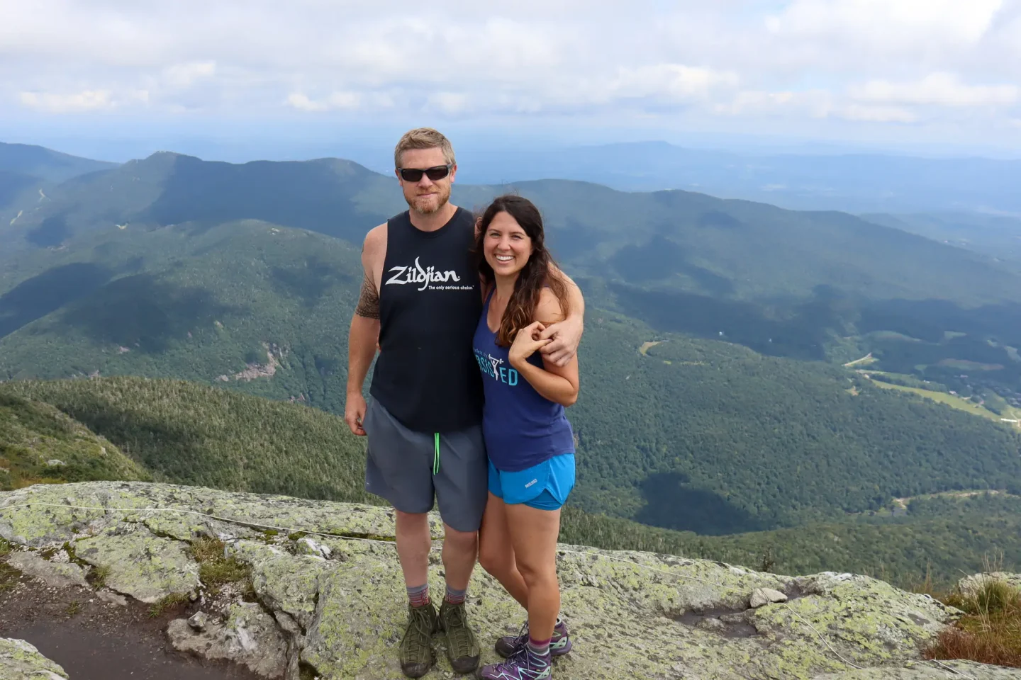 man and woman on top of the best hike and tallest mountain in vermont