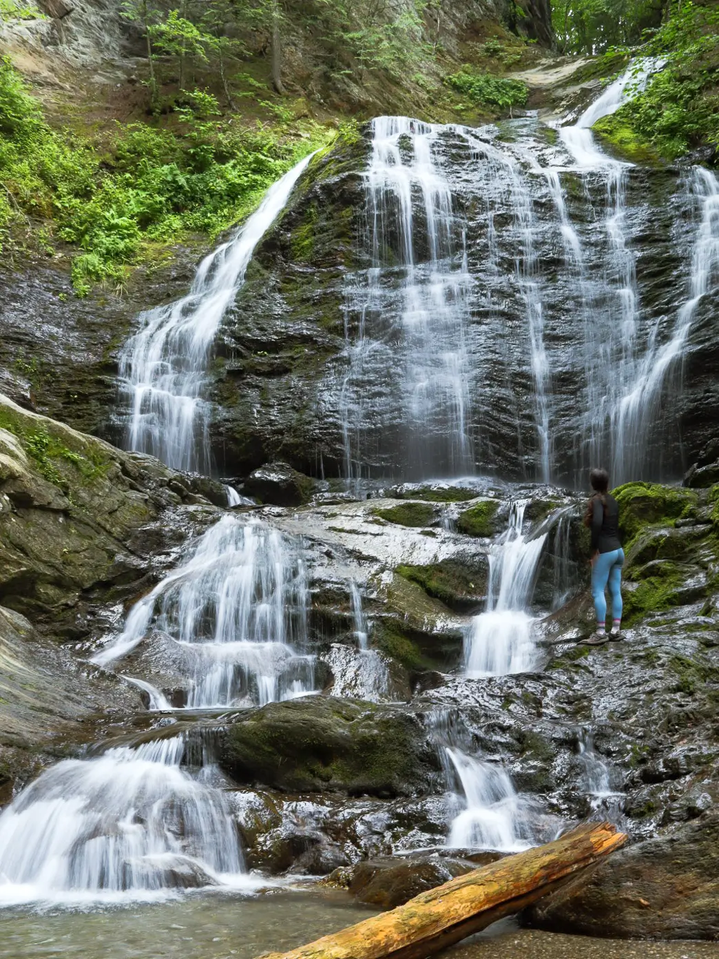 woman standing by tallest waterfall in vermont