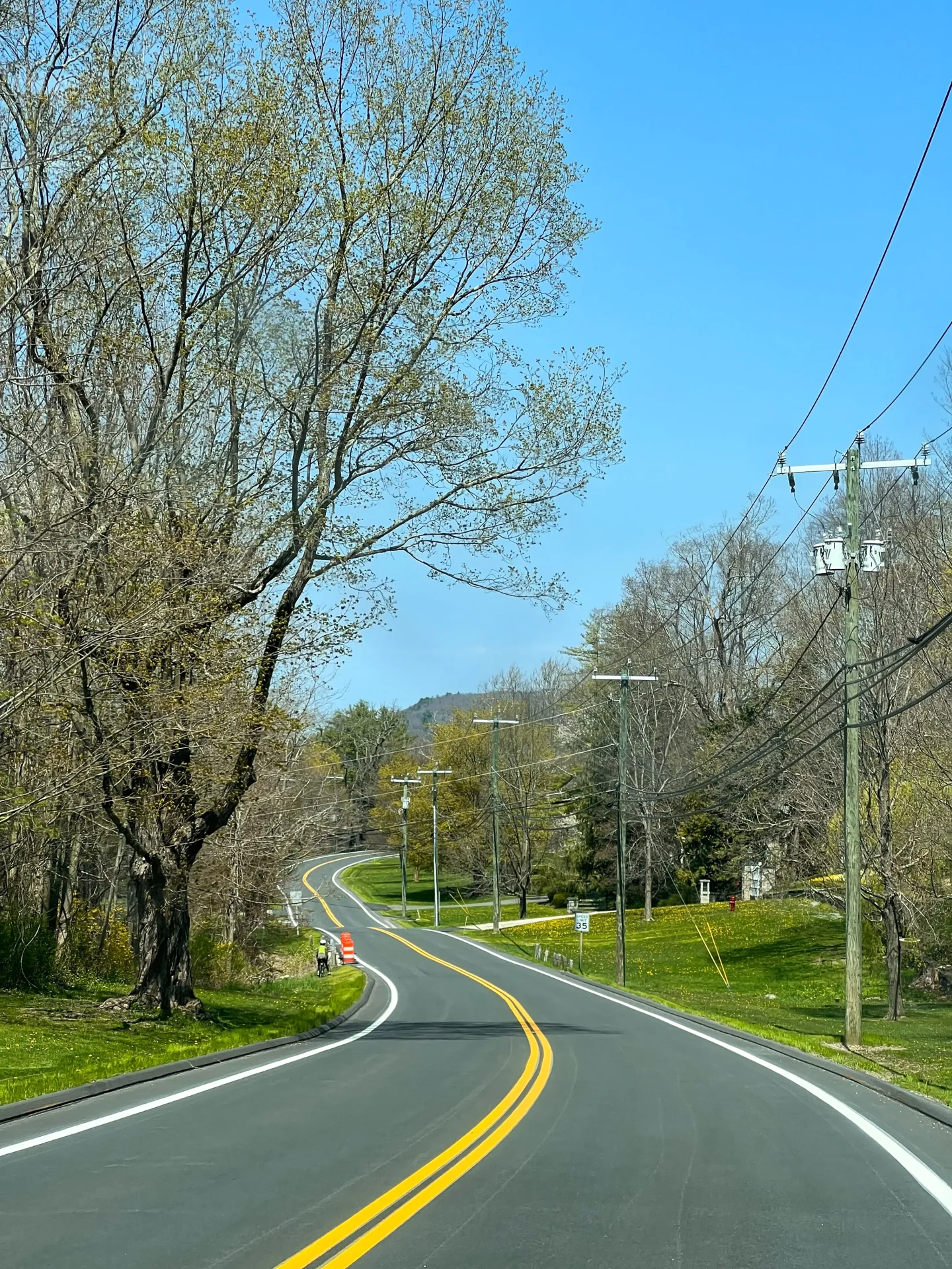 winding road in sharon ct with spring green grass