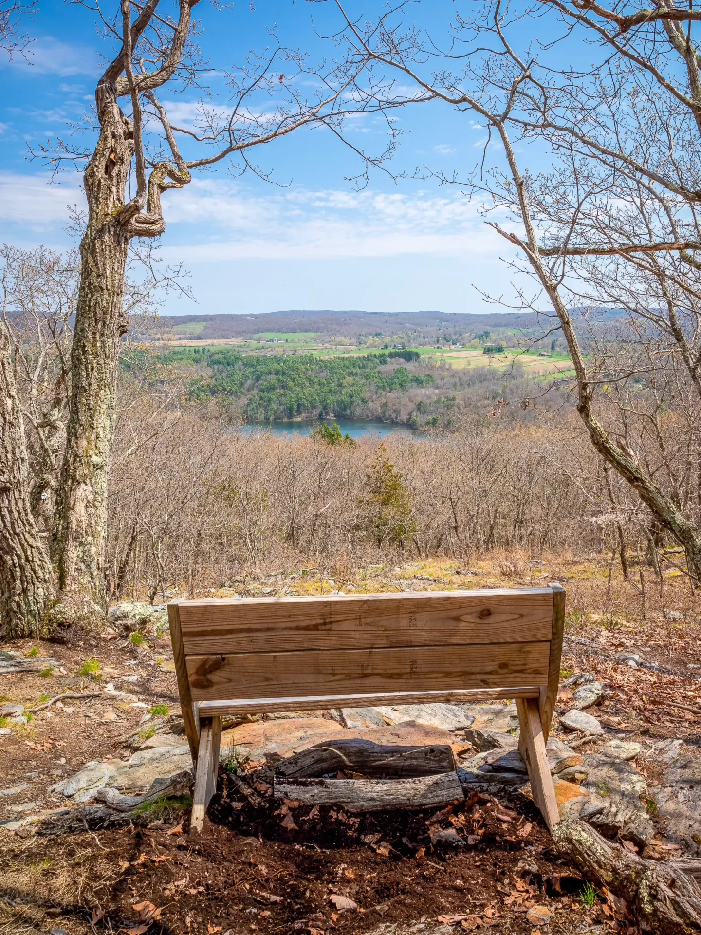 wooden bench looking out at open view at garrett goodbody land trust in sharon connecticut