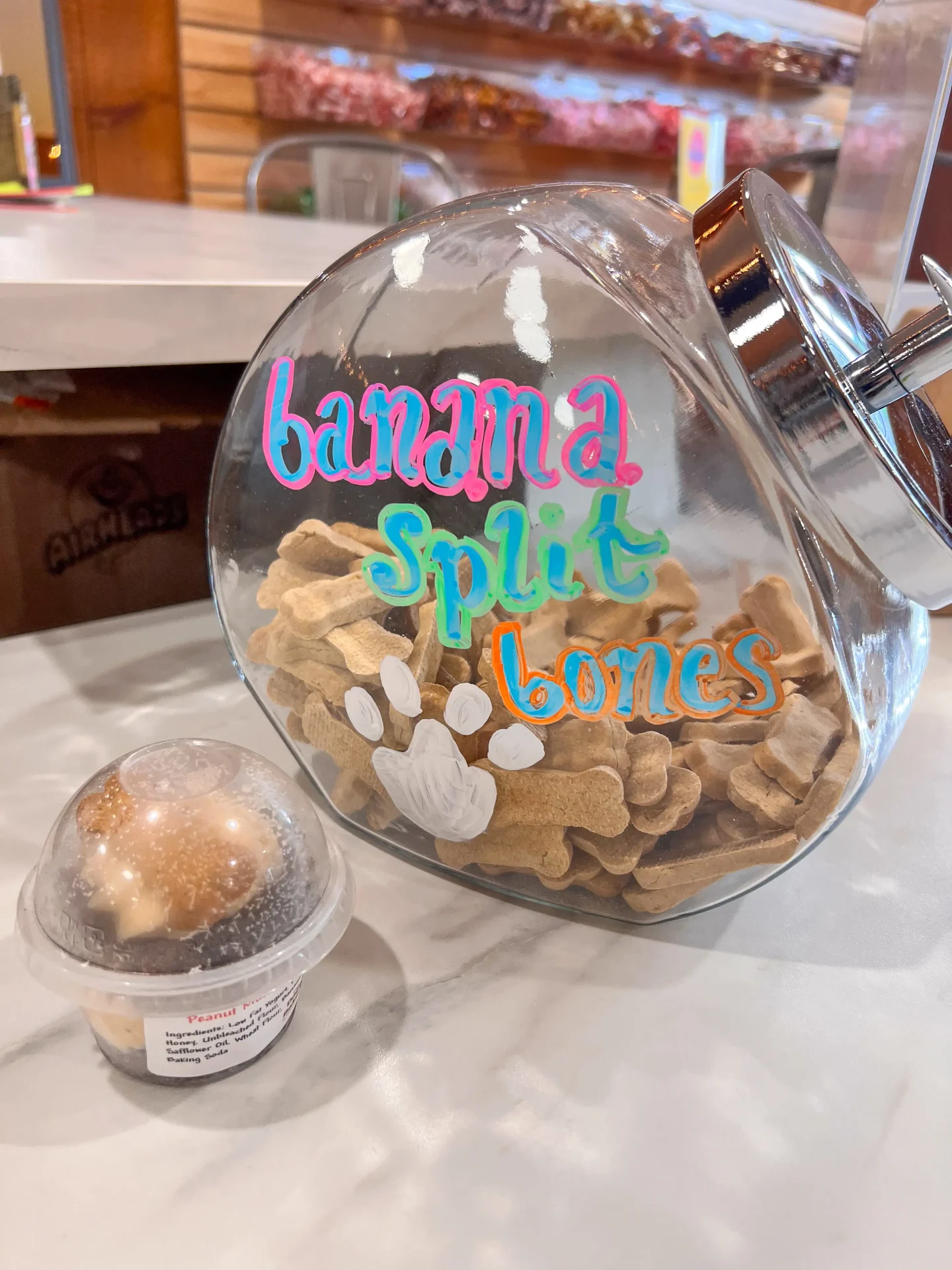 dog treats in a glass jar with doggy ice cream on the side