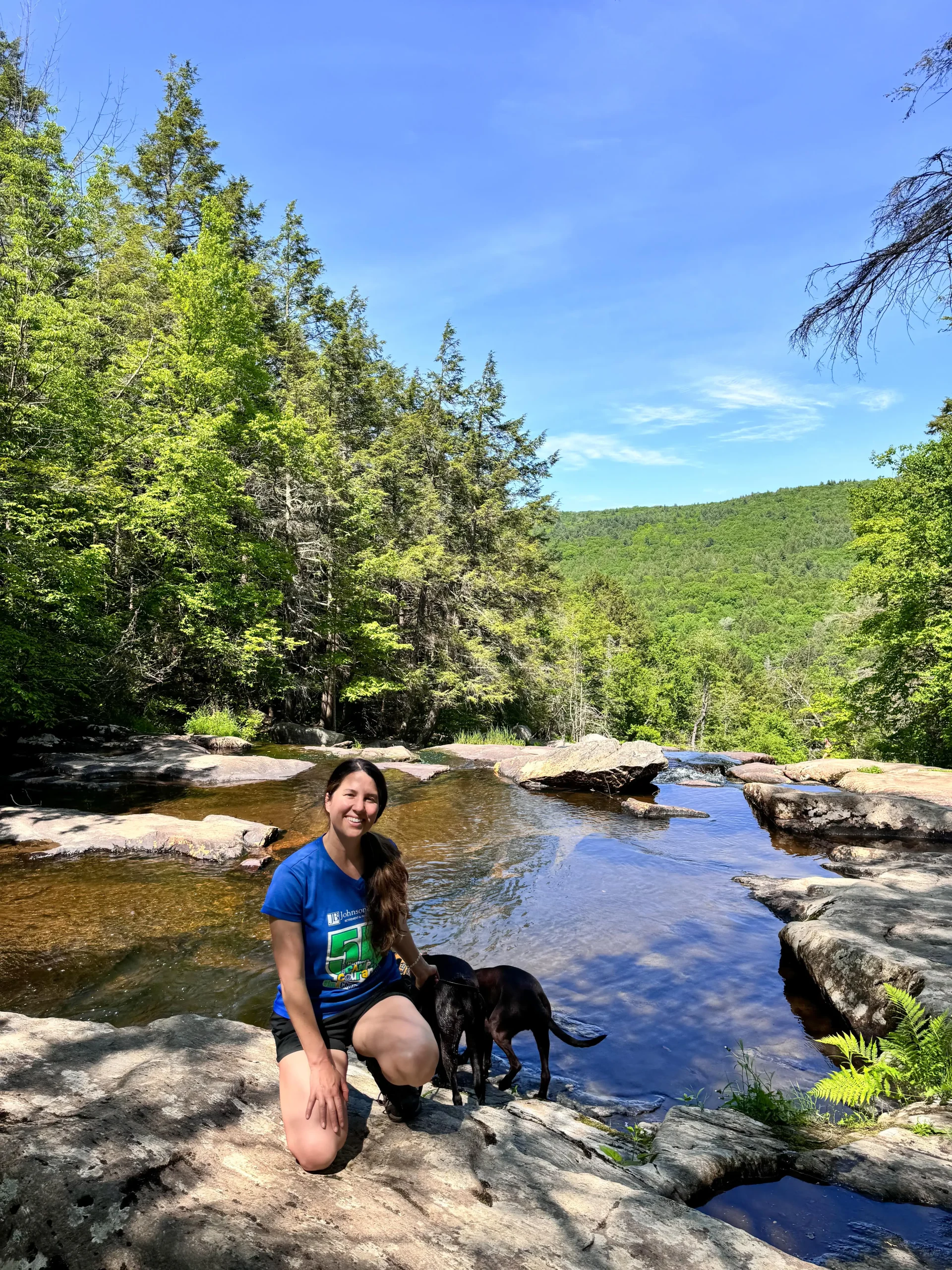 woman in blue shirt in summer at massachusetts waterfall