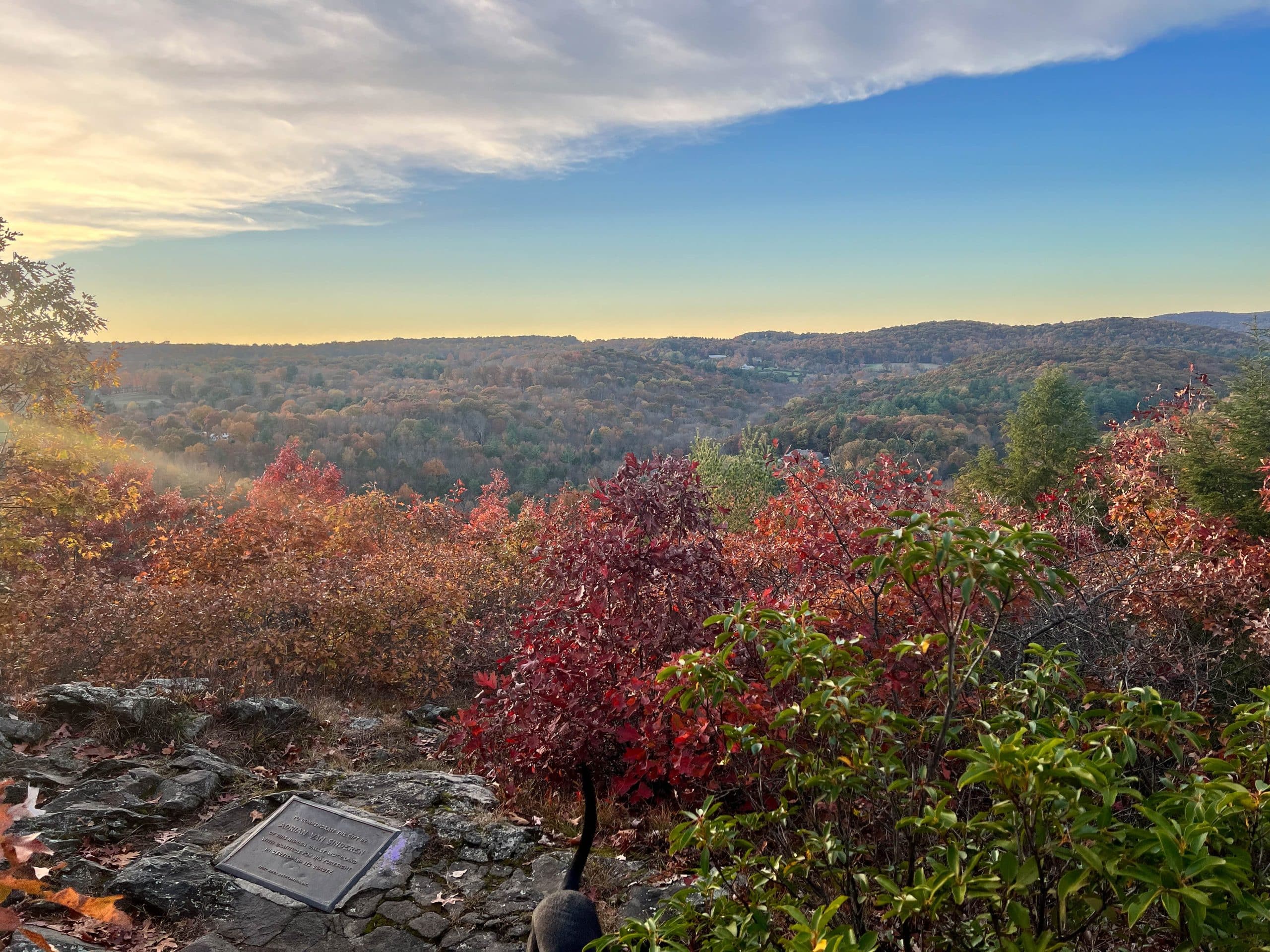 fall hiking view with red trees and blue skies at hidden valley preserve in washington connecticut