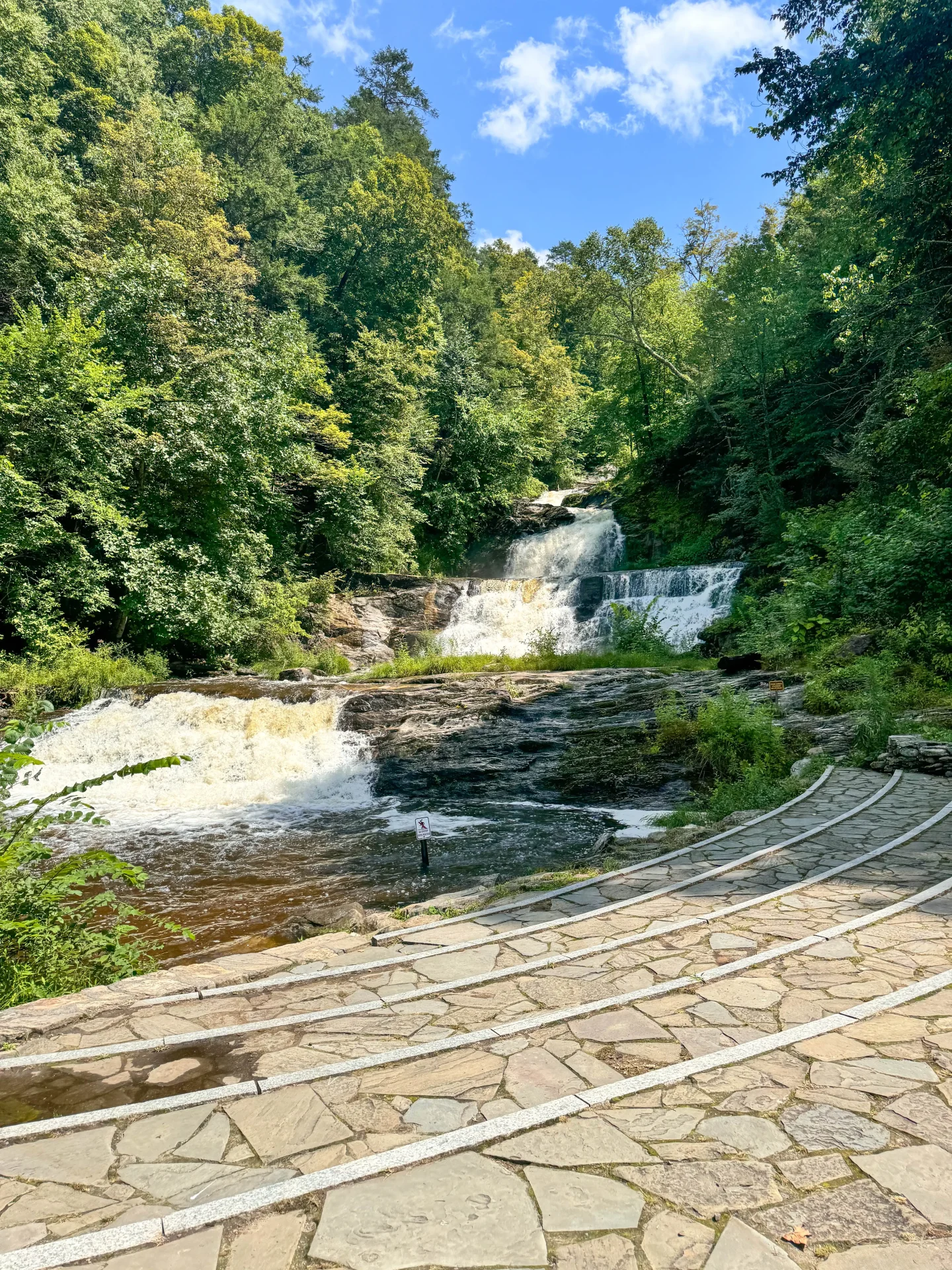 kent falls waterfalls in the summer surrounded by green trees