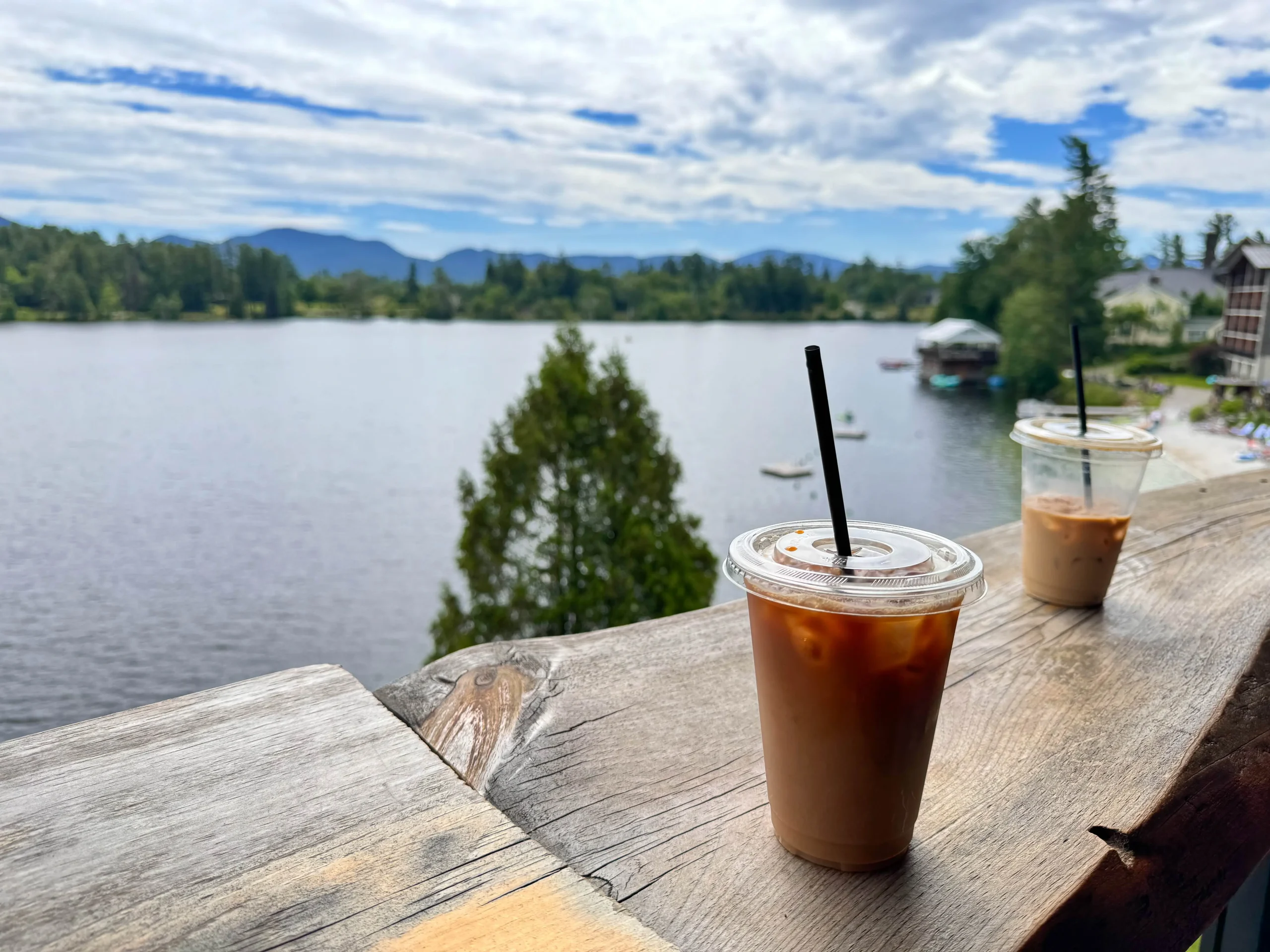 iced coffee on the deck of the coffee bar in lake placid with a view of the lake