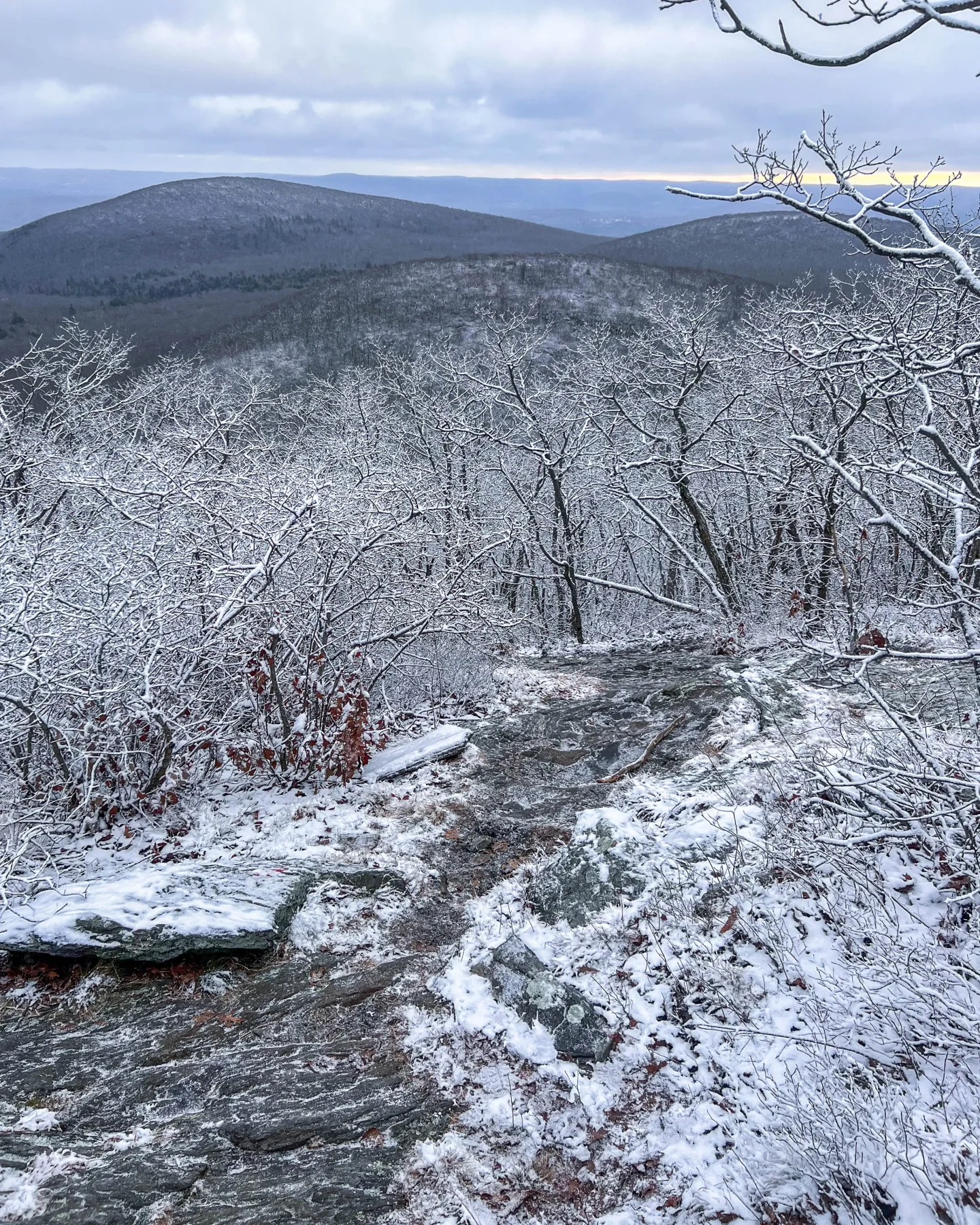 hiking up to bear mountain in winter in connecticut