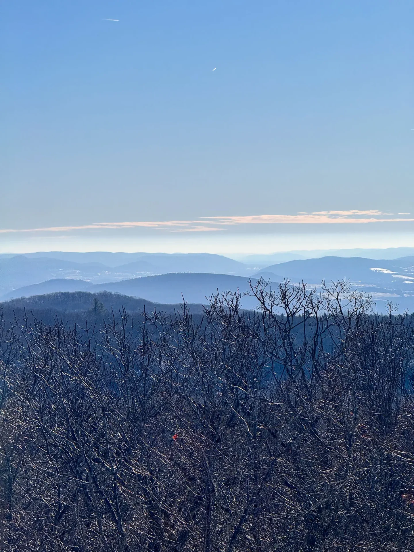 winter view of bare snowy mountains in connecticut with blue skies in salisbury