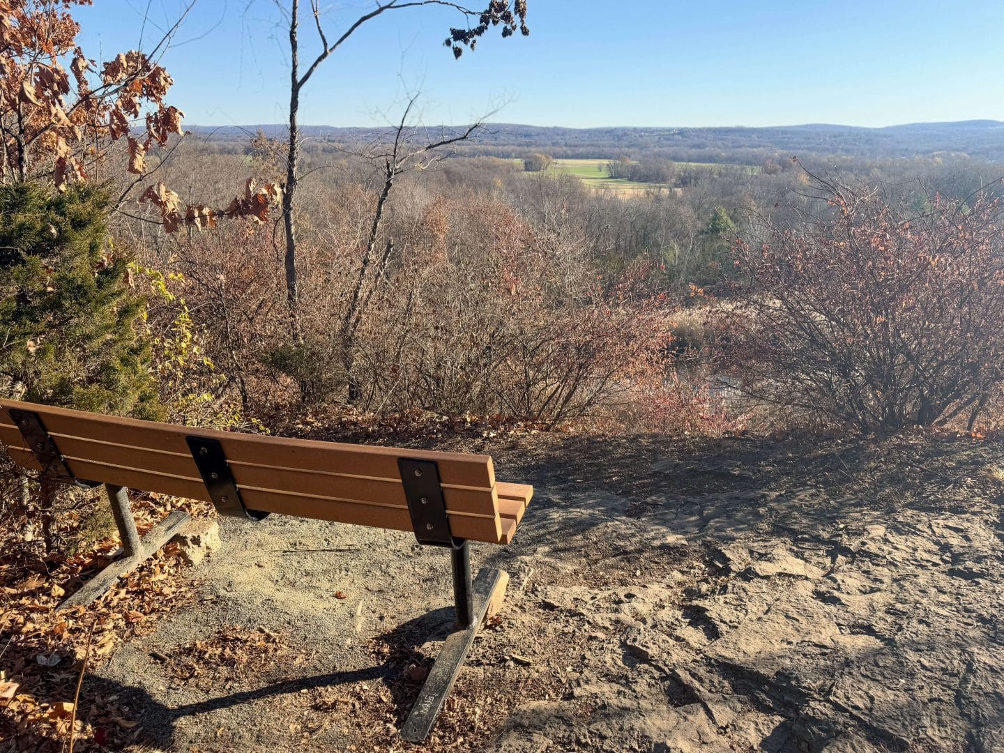 view from rocky hill quarry hike in connecticut with a bench on top