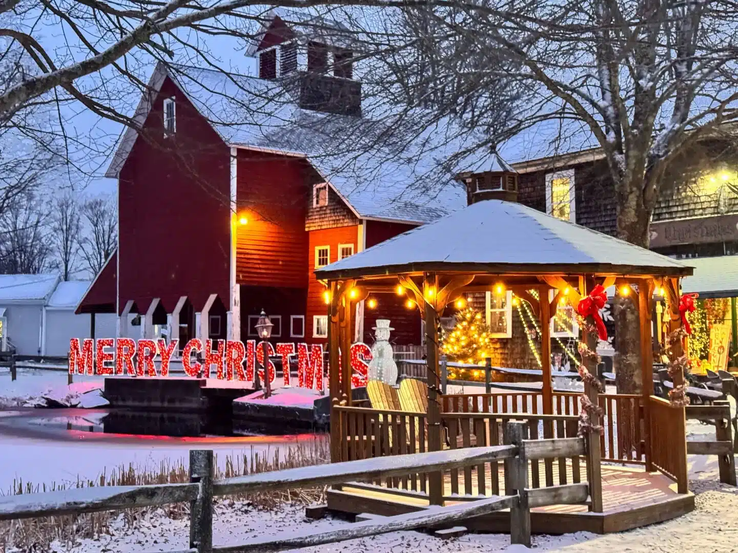 red barn store in granby in the snow with white lights on the outside.