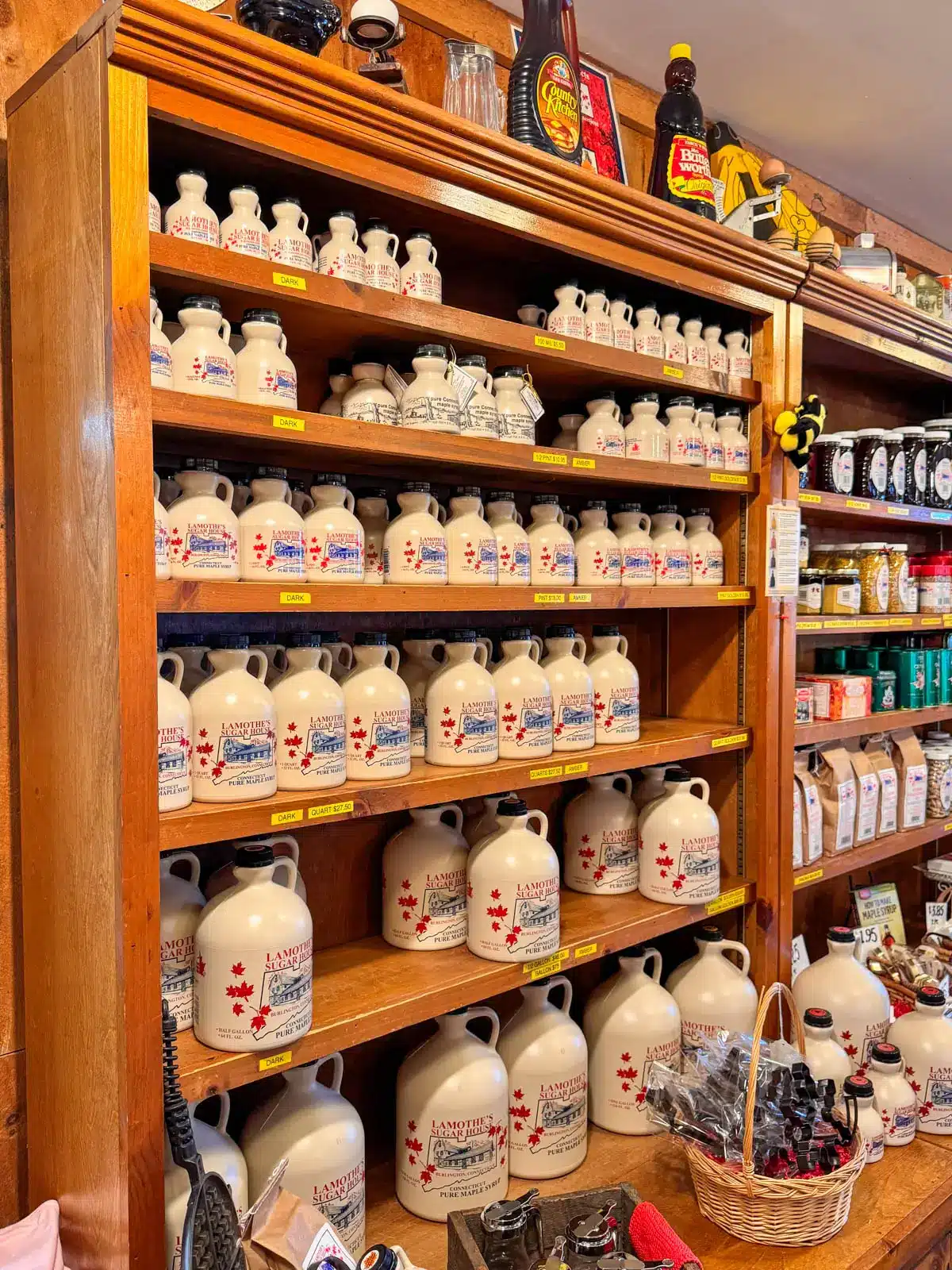 wooden shelves lined with maple syrup bottles.