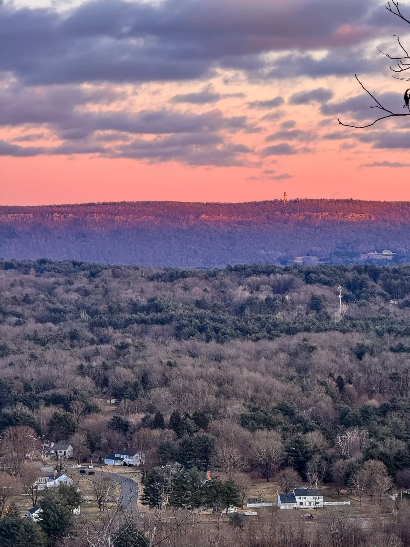 pink sunset tones in sky on hike at onion mountain in connecticut