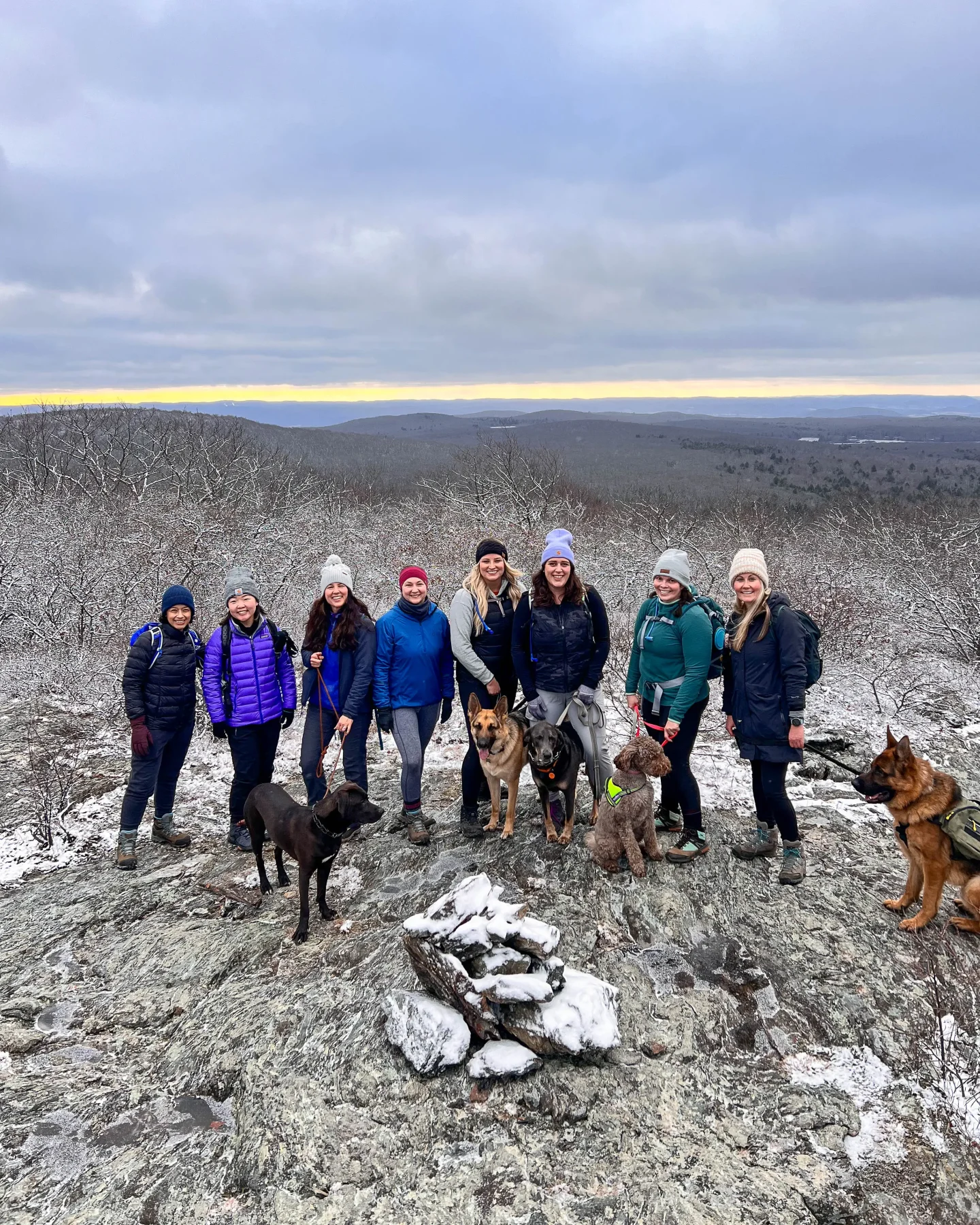 group of woman and dogs winter hiking in connecticut