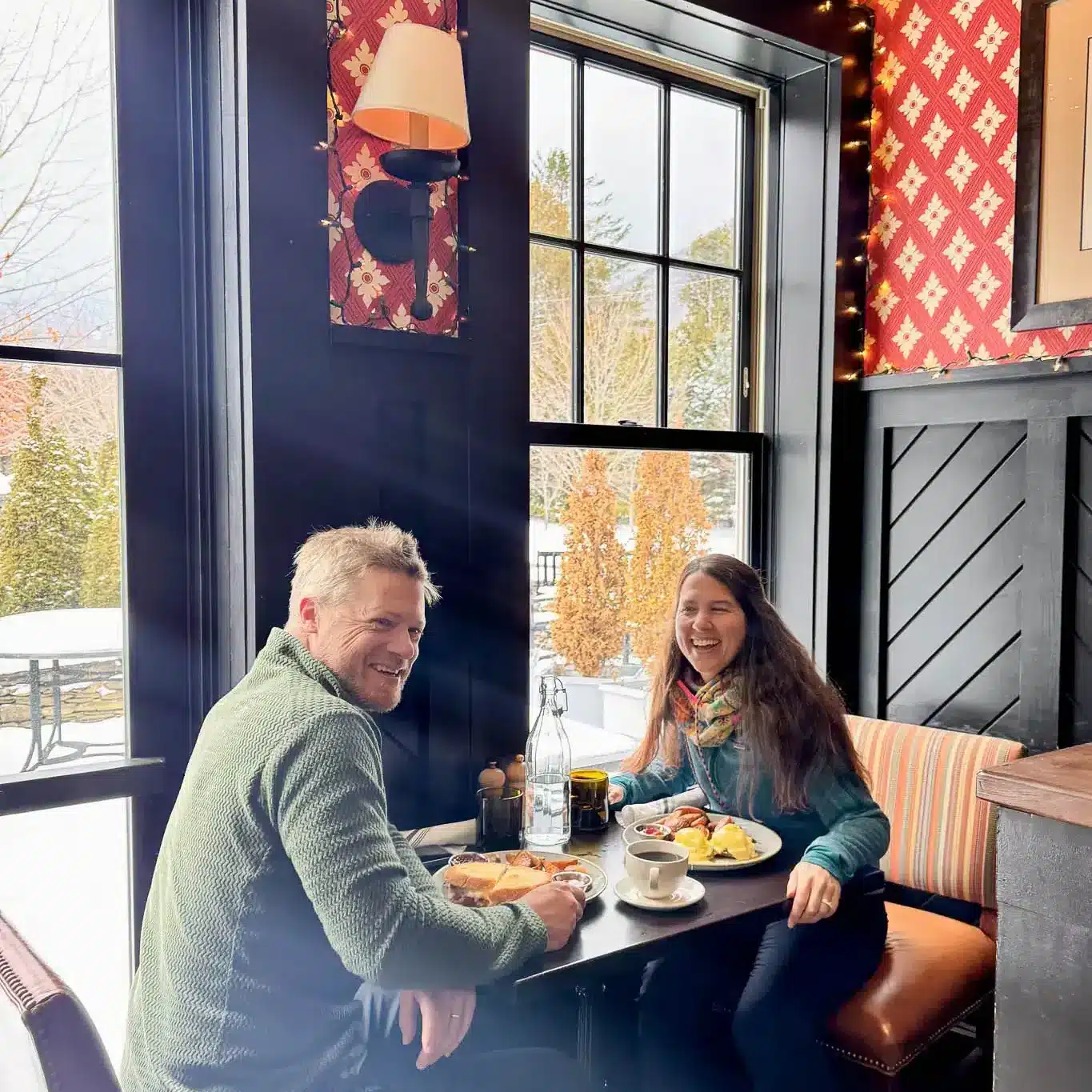 couple smiling at brunch at copper grouse with eggs hollandaise