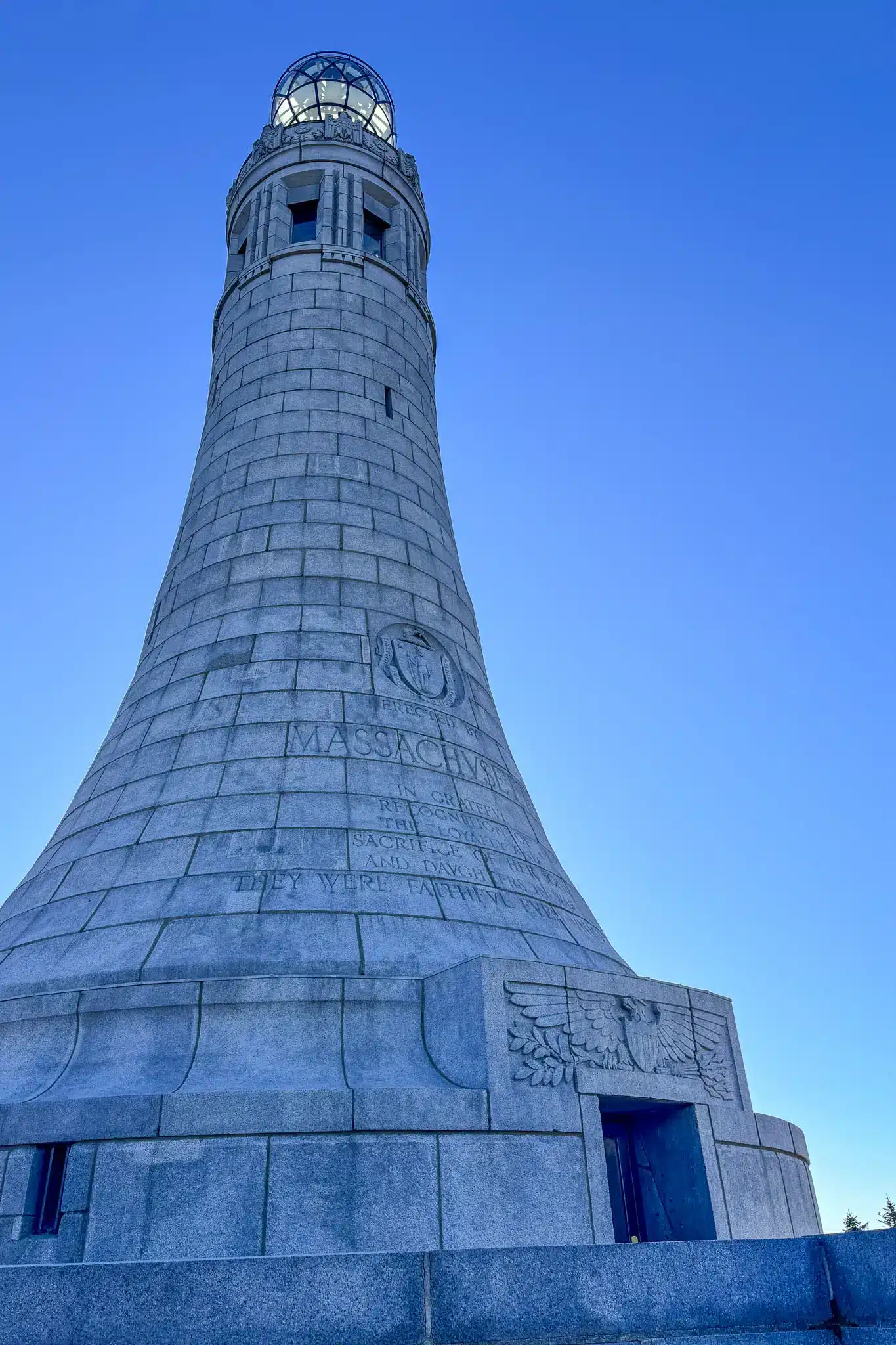 veterans memorial tower at top of mount greylock with blue sky in background