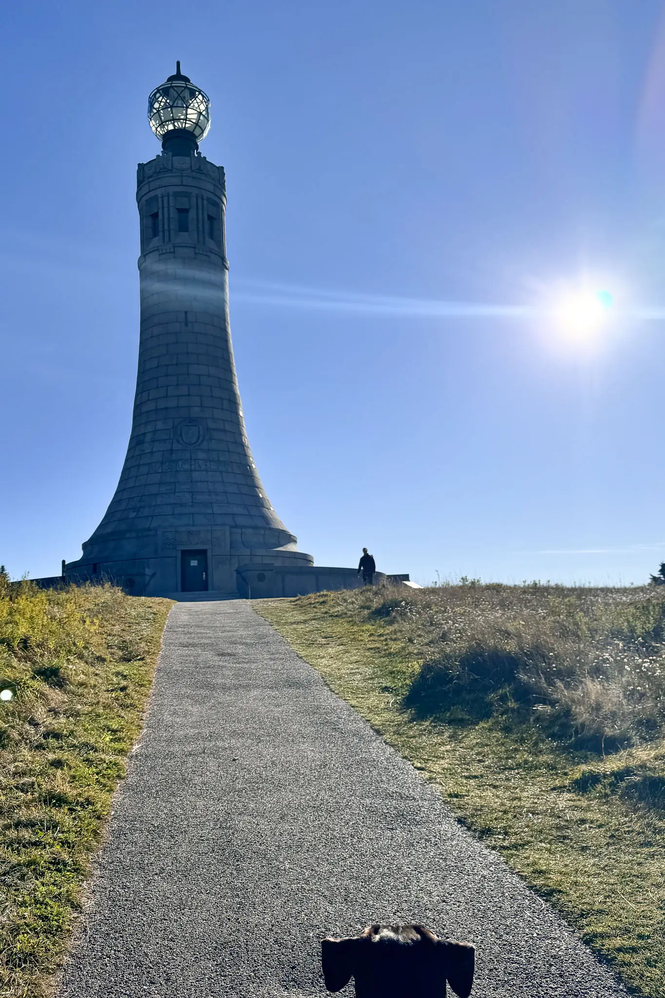 veterans memorial tower at top of mount greylock with blue sky in background