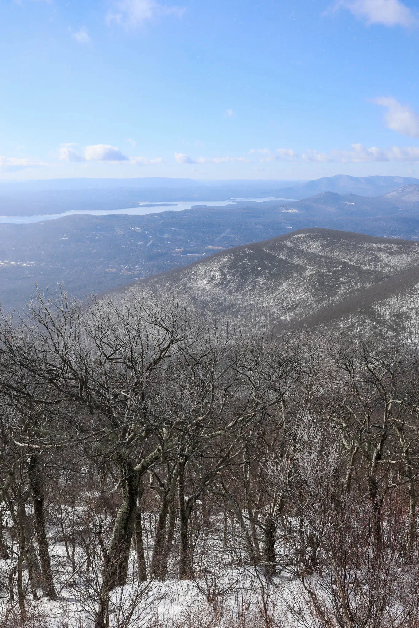 view from overlook mountain fire tower in woodstock new york with blue skies and mountains in the distance