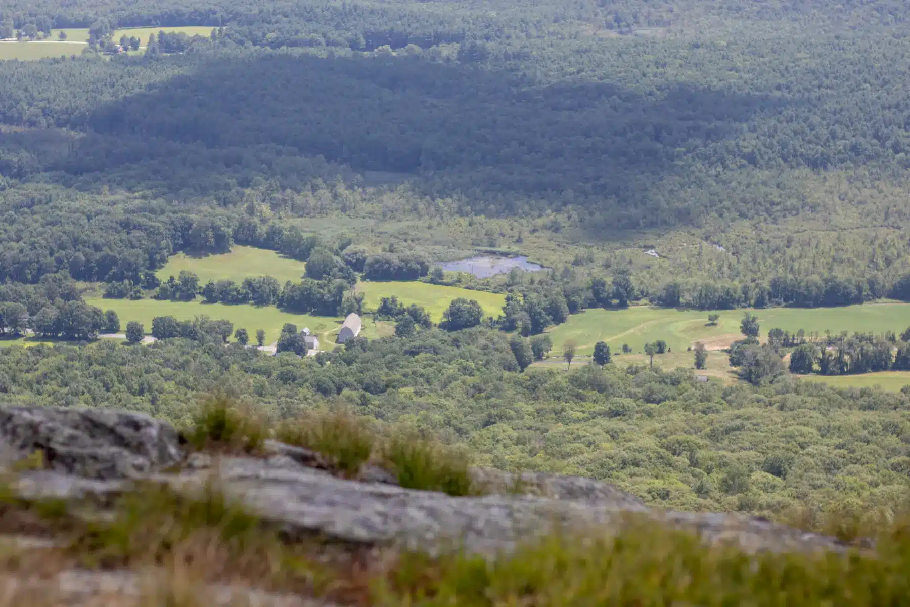 landscape shot of green hills in distance from atop Mount Race in Massachusetts.