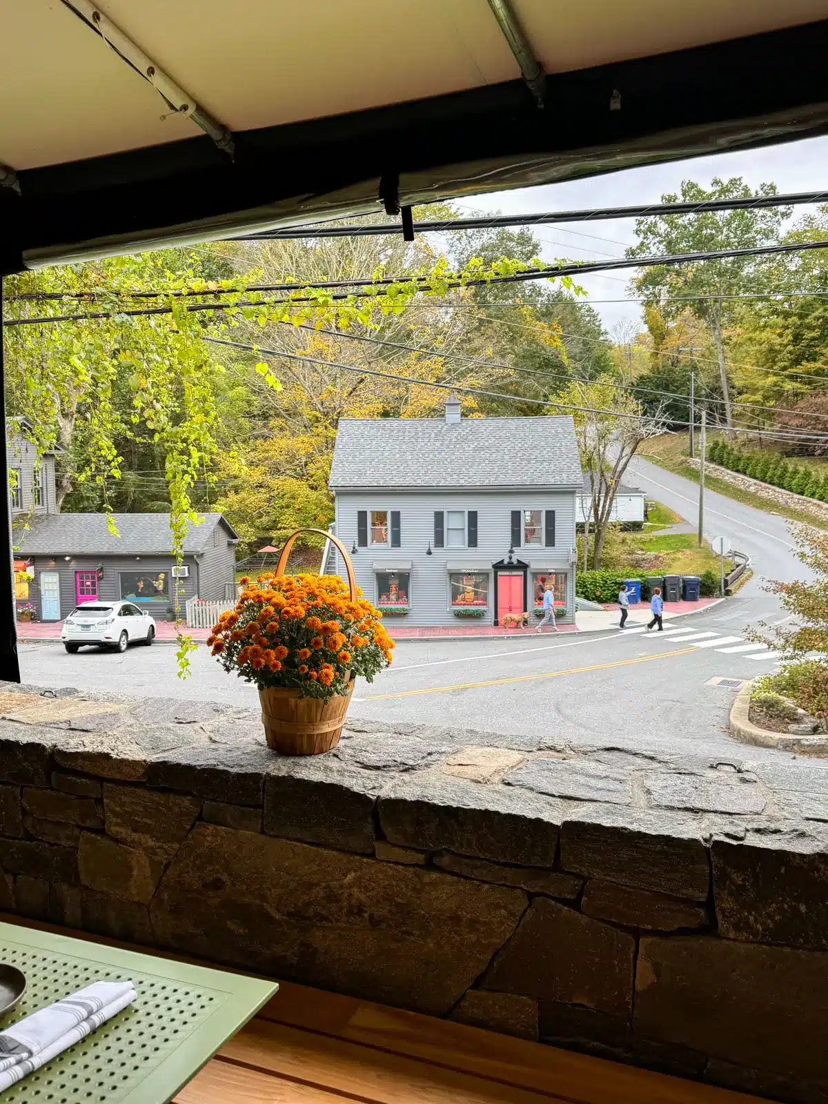 downtown new preston in fall with white colonial storefront shop.