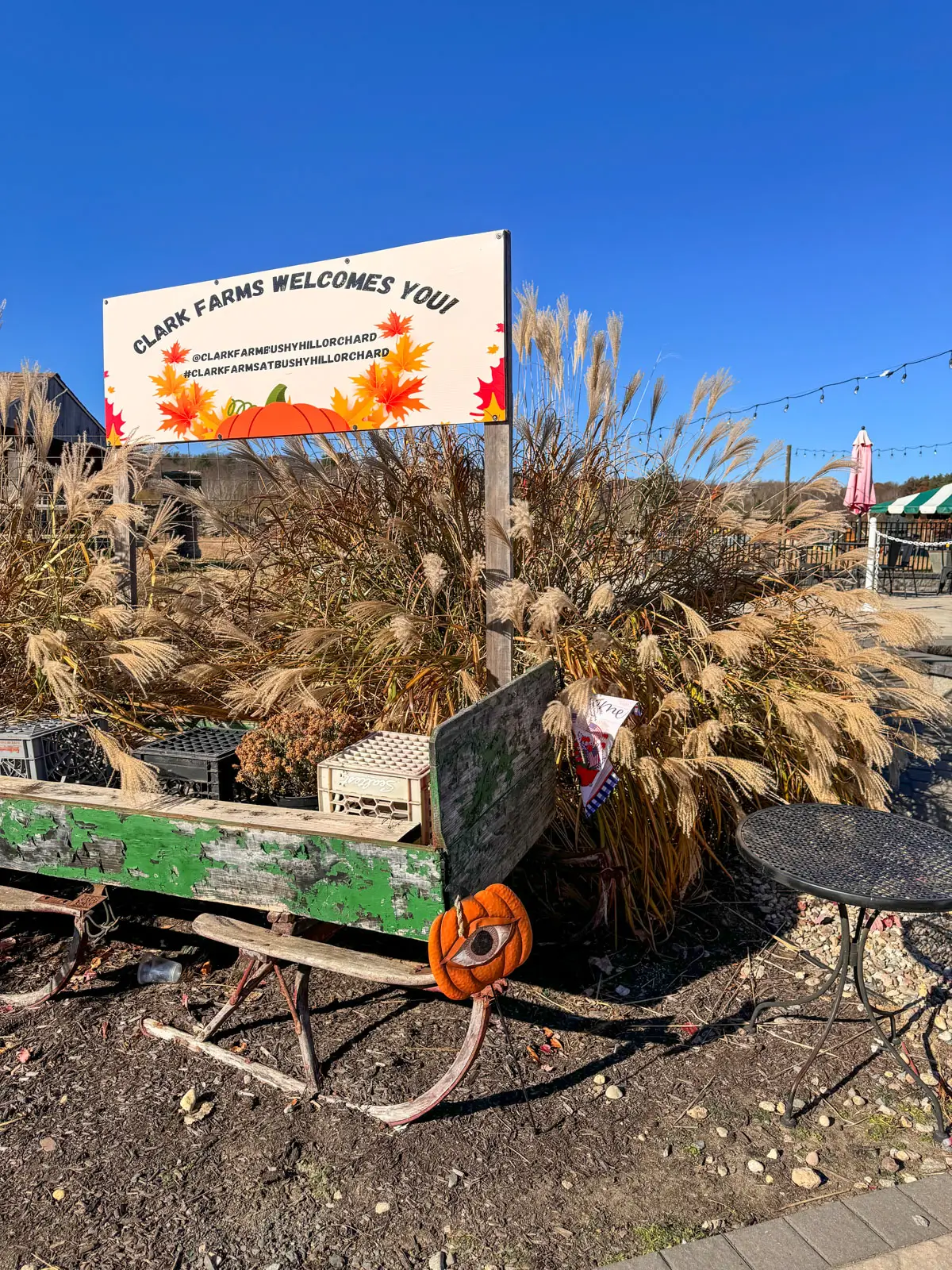 clark farm sign in granby CT with blue sky above.