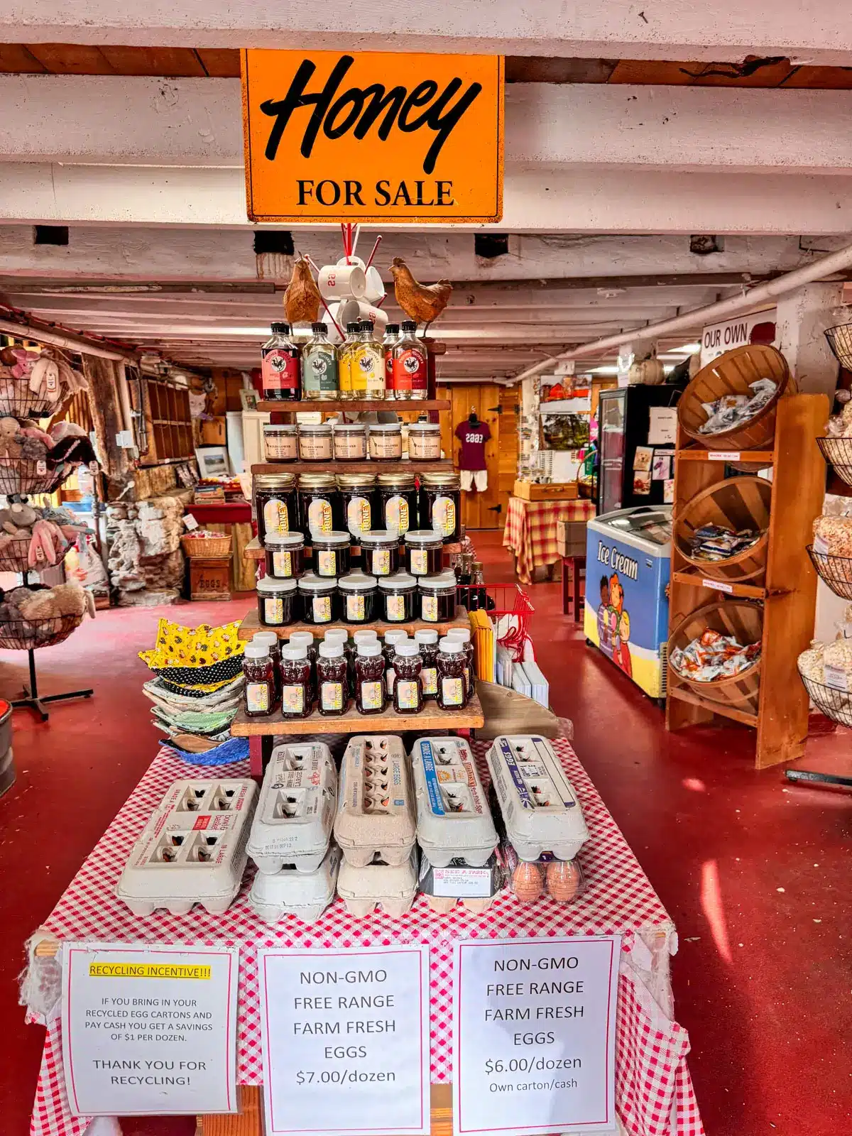 inside flamig farm store in connecticut in fall with table of egg cartons and local honey.