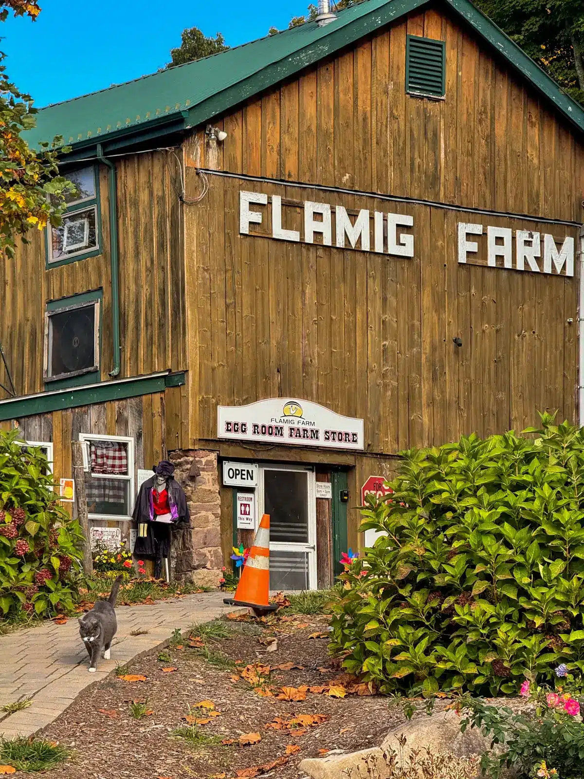 brown barn with white writing saying Flamig Farm.