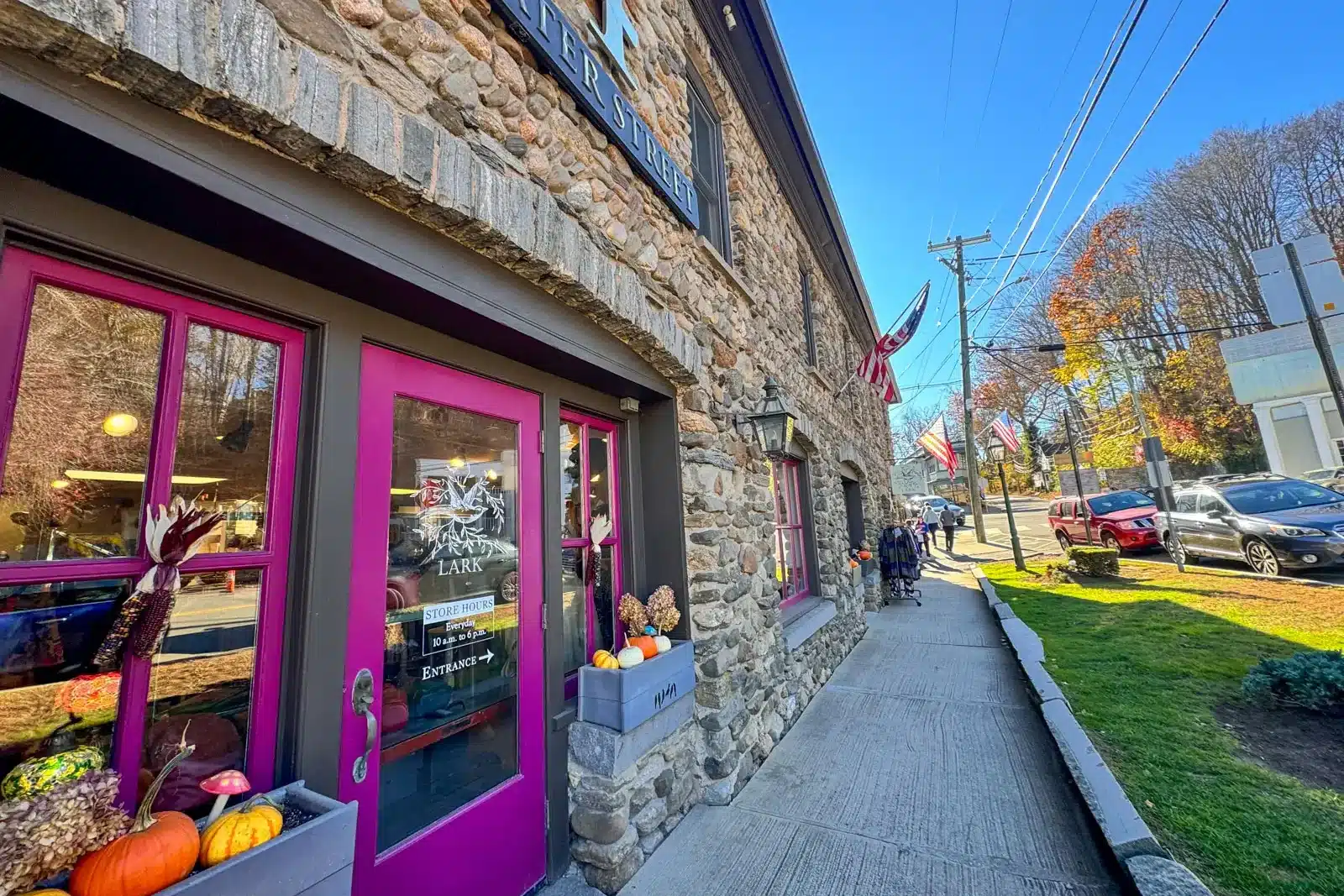 brick storefront building along water street in chester with bright purple door.