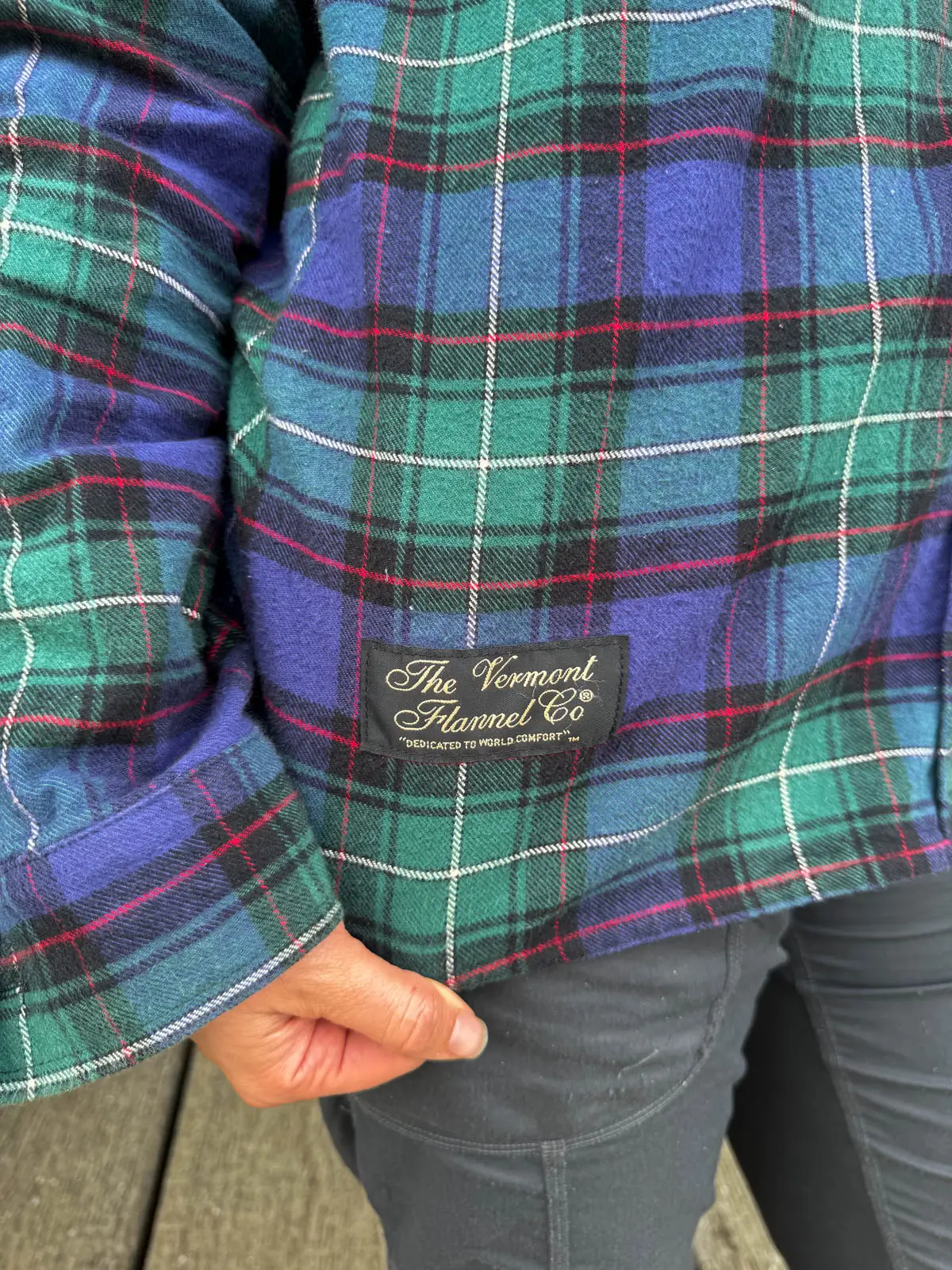 up close photo of woman wearing a green and blue plaid from the vermont flannel company.