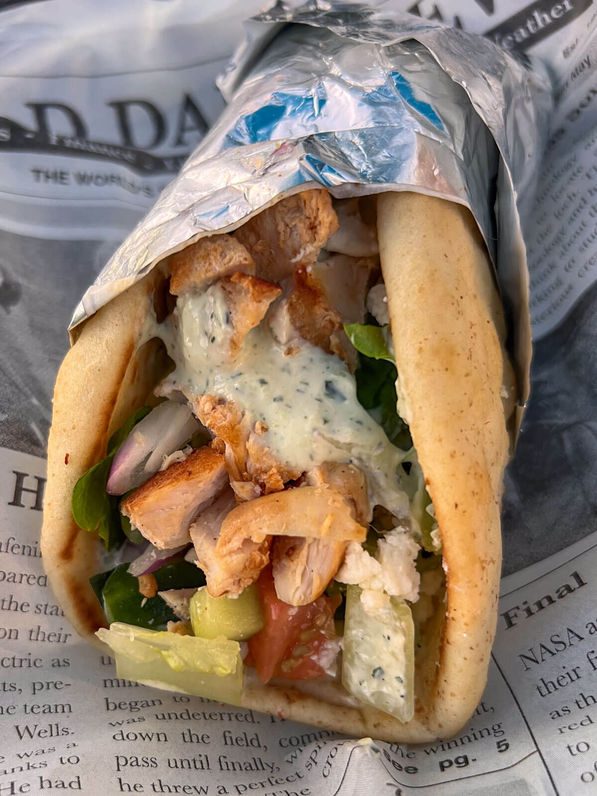 greek gyro wrap in tin foil with grilled chicken and tatziki sauce at a vanilla ice cream cone with a caramel swirl at grassroots in simsbury ct.