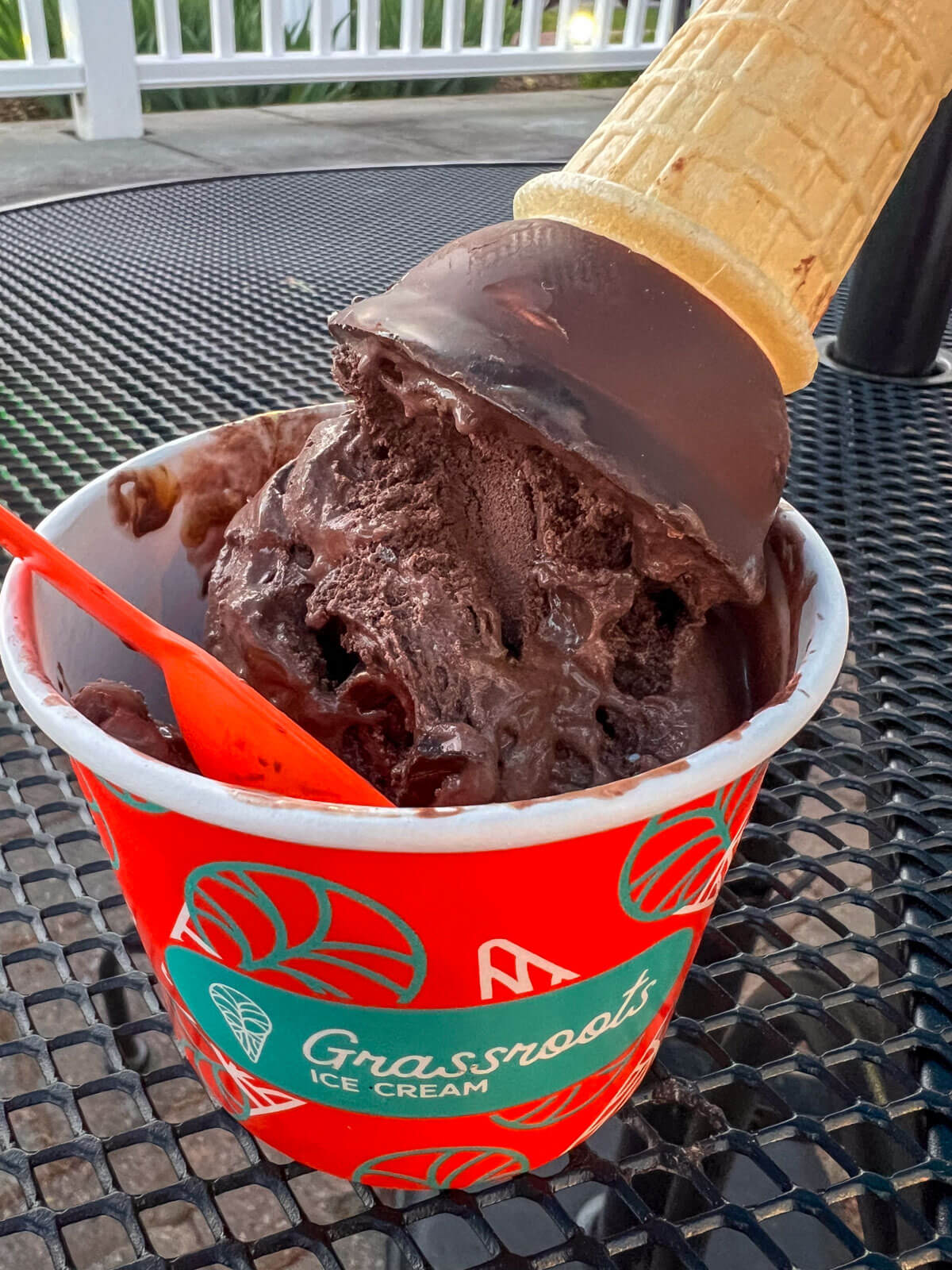 dark chocolate ice cream in a red ice cream cup with red spoon at grassroots in simsbury ct.