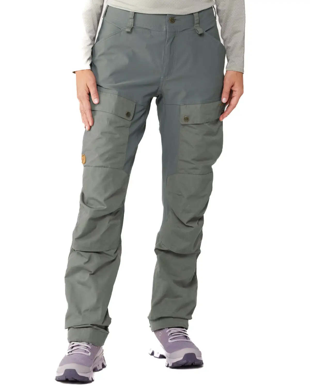 fjallraven womens winter hiking pants in light gray with army style pocket and shell snowpant material.