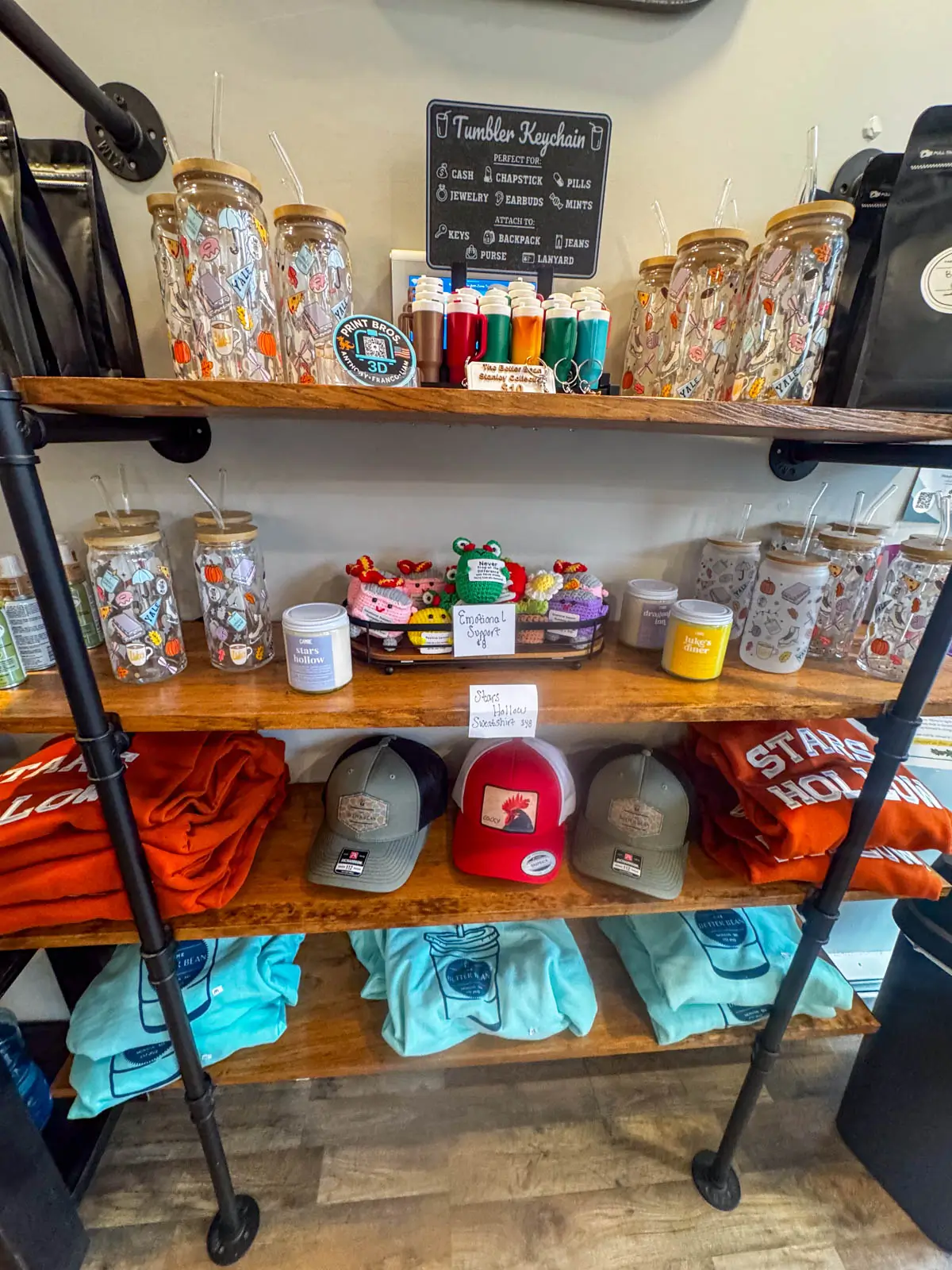 multiple shelves of merchandise and gift items at better bean coffee shop in downtown monson massachusetts.