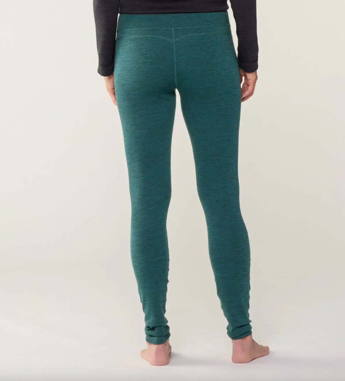 women's smartwool thermal leggings for hiking in the snow in dark green.