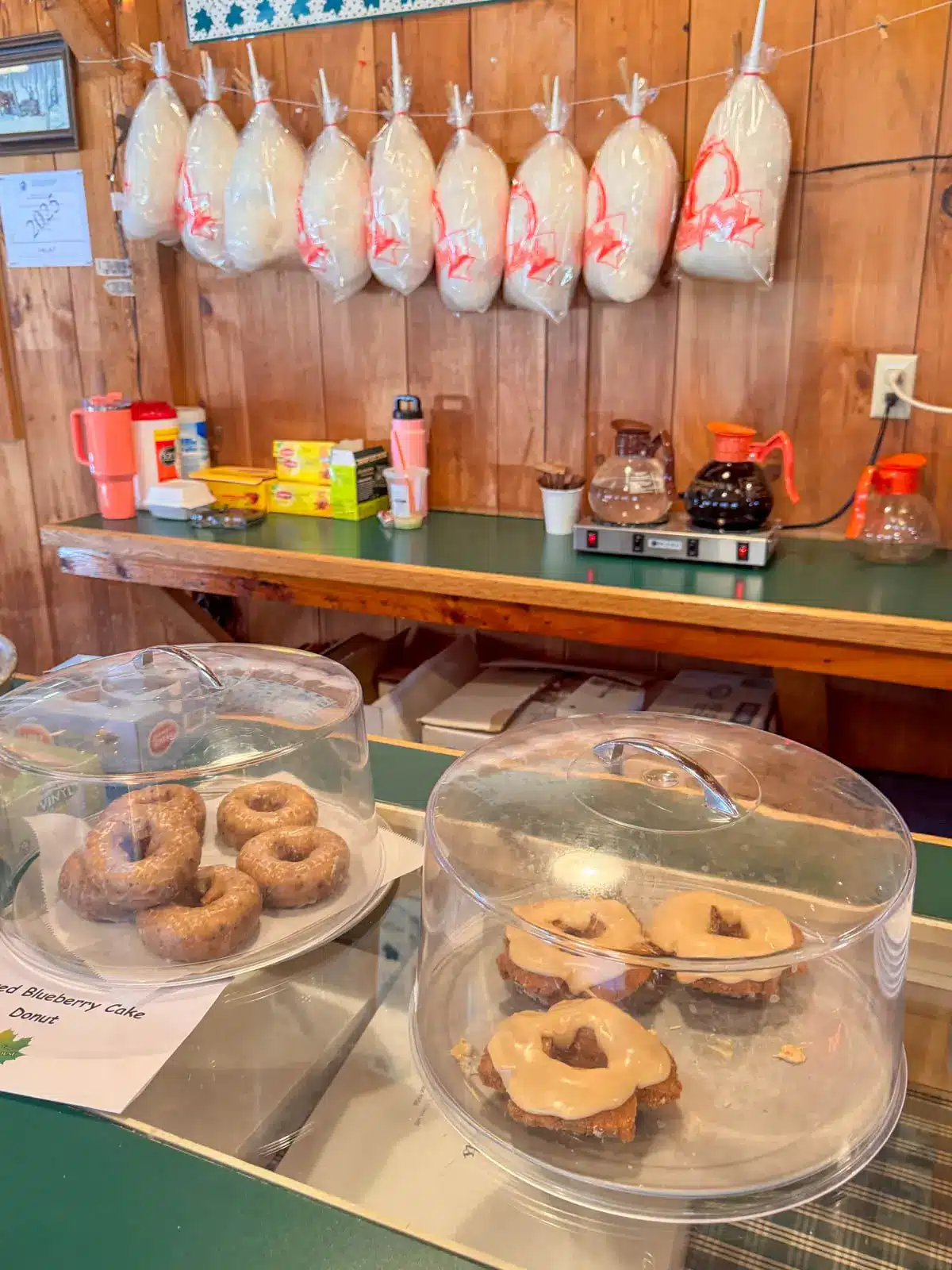 glazed donuts inside desert cases at williams farm sugarhouse in massachusetts.