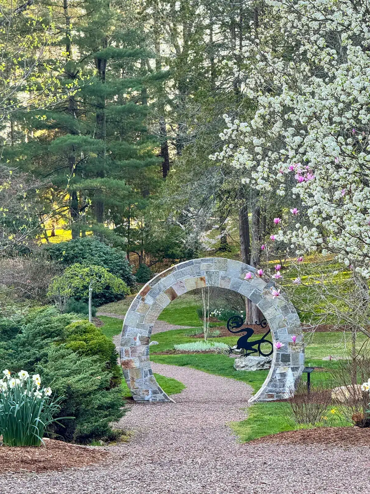 stone walkway surrounded by flower in wickham park in connecticut.