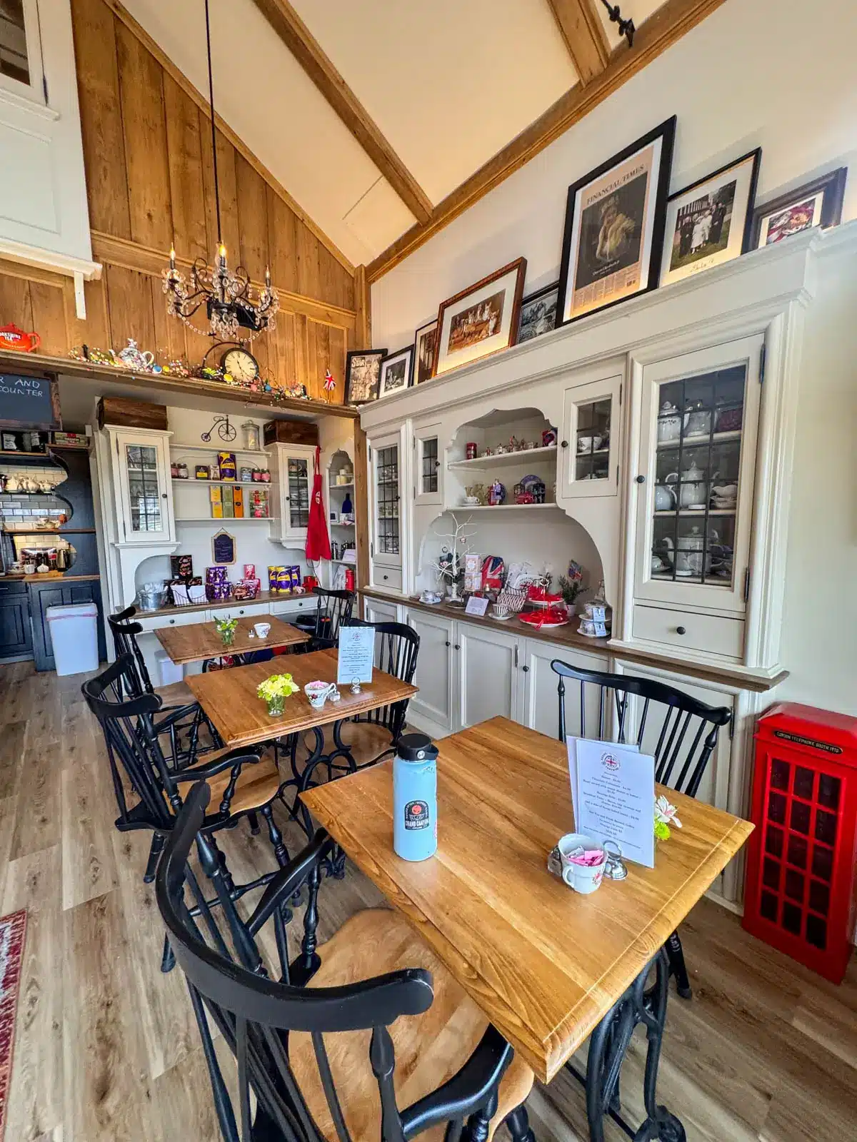inside of penny farthing tea shop in litchfield connecticut with wooden tables and chairs.
